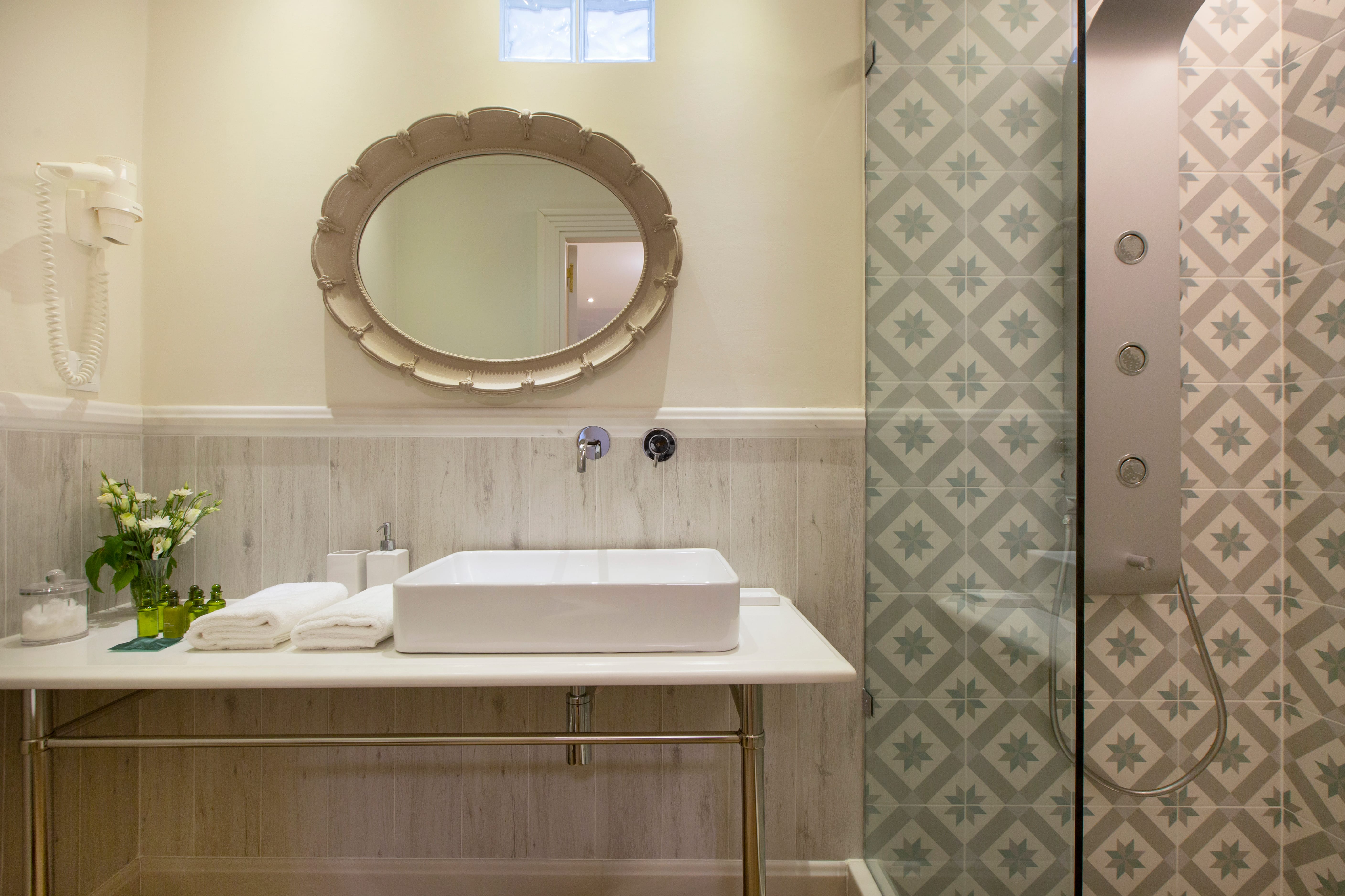 a bathroom with a round mirror