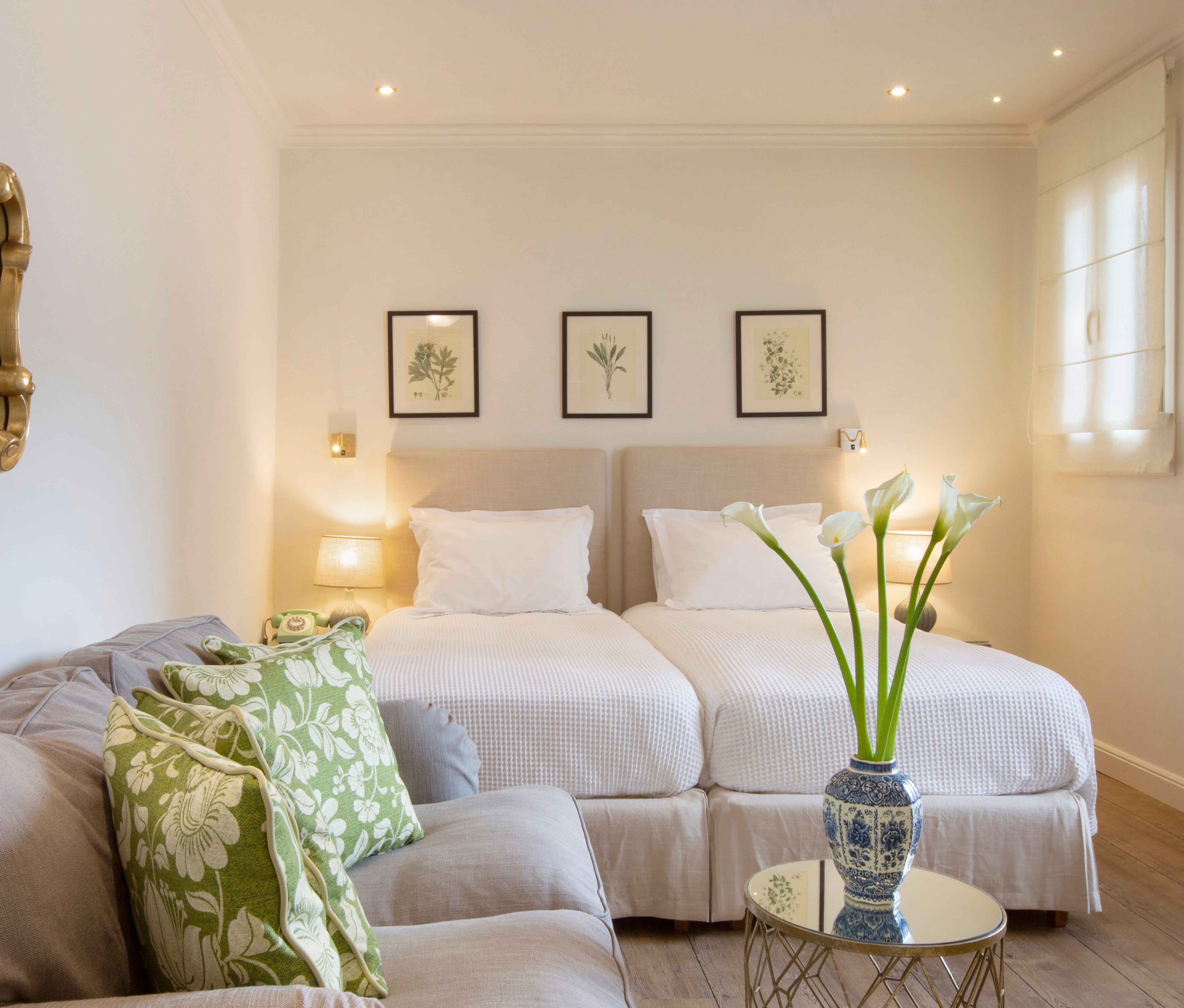 a room with a couch and a table with flowers on it