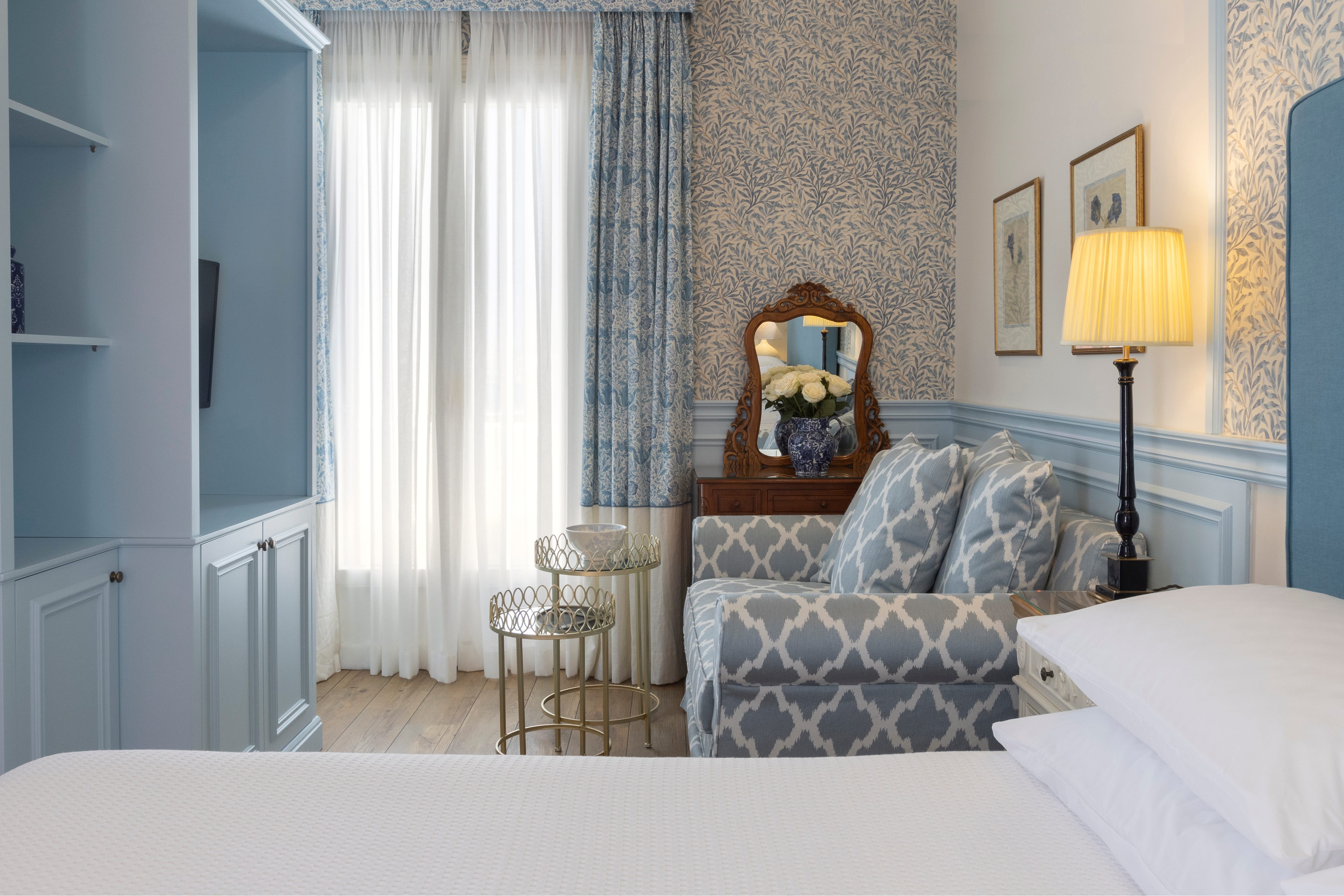 a bedroom with a bed and a lamp