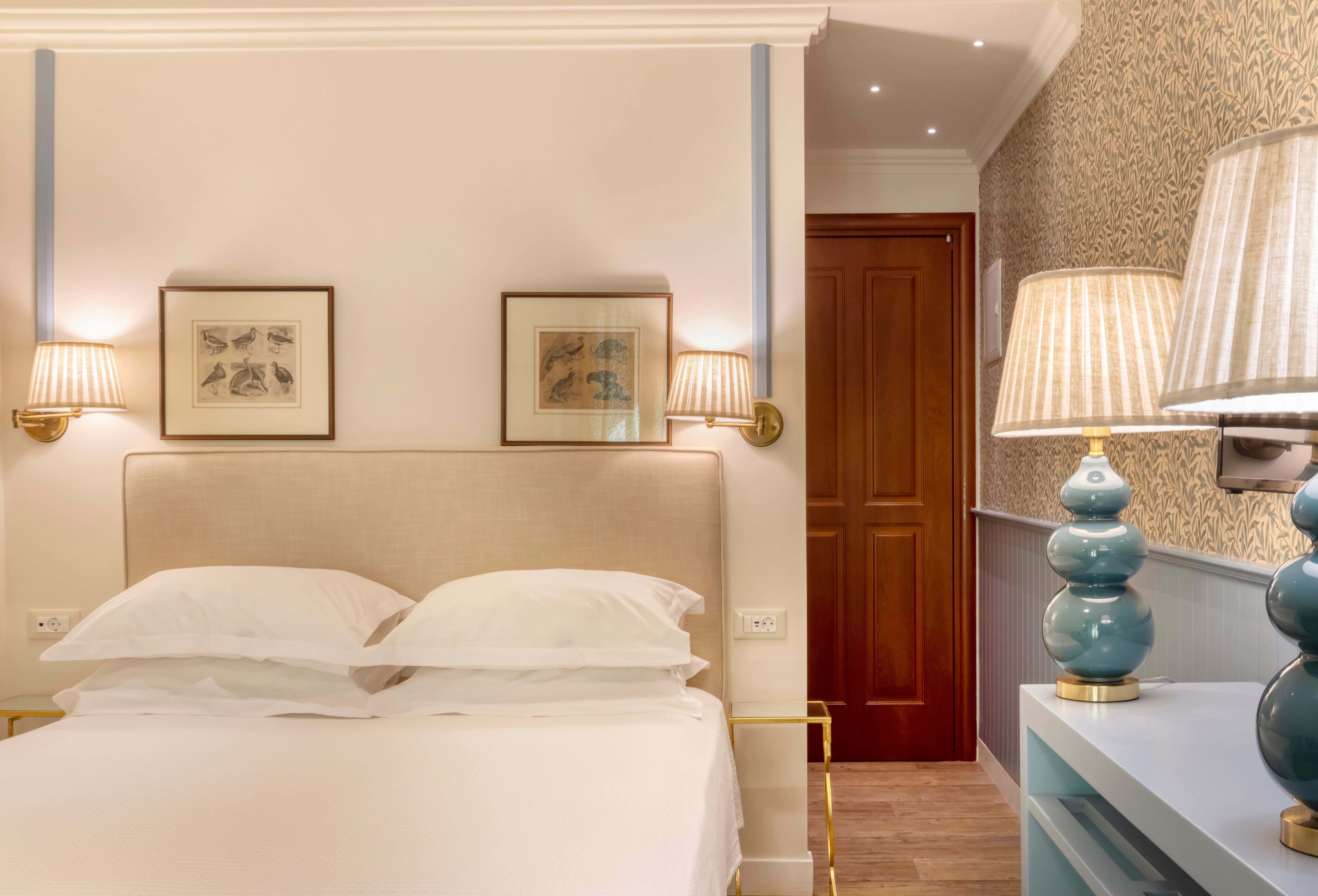 a bedroom with a bed and lamps