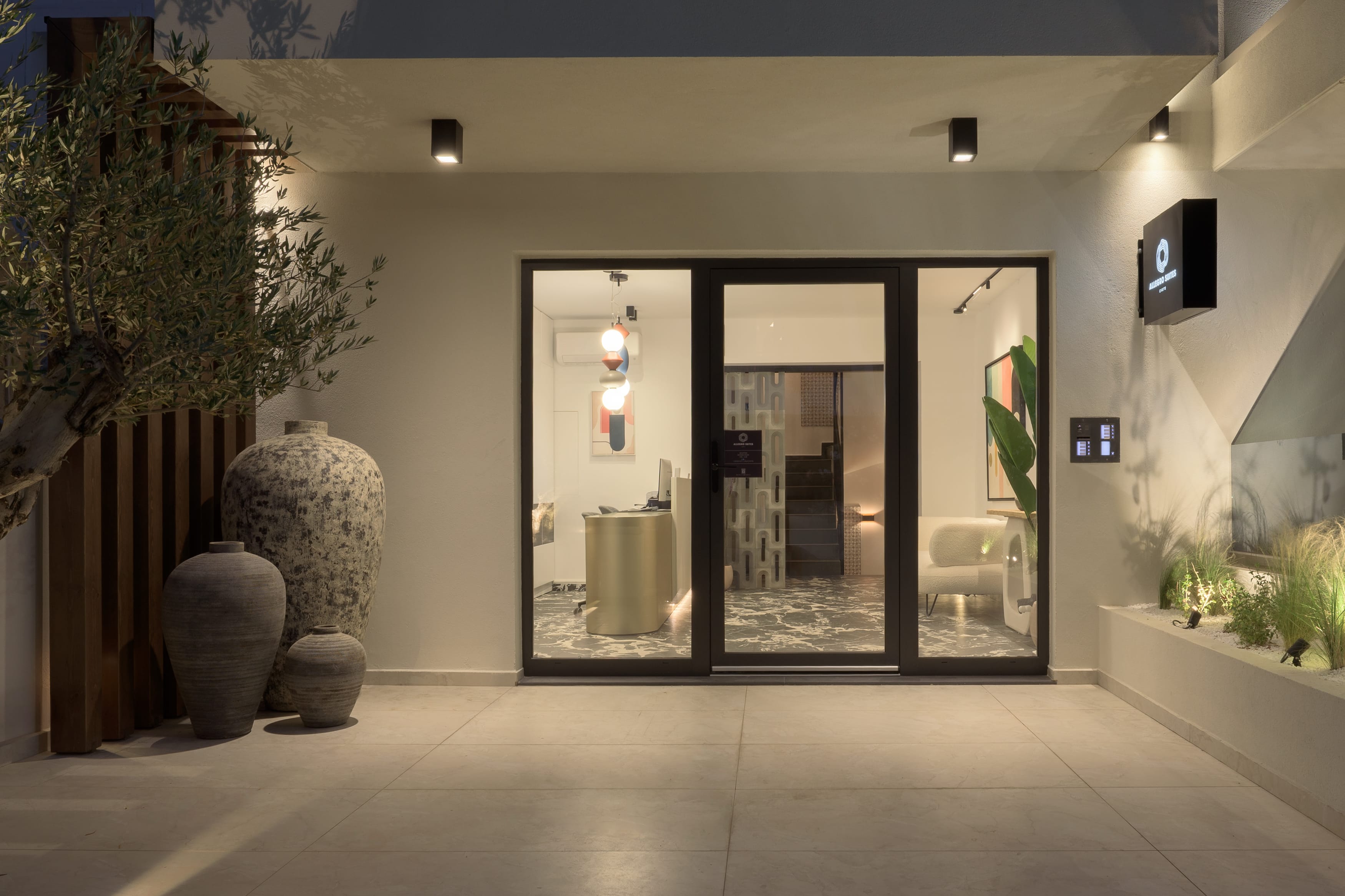 a room with a glass door and a planter and a plant