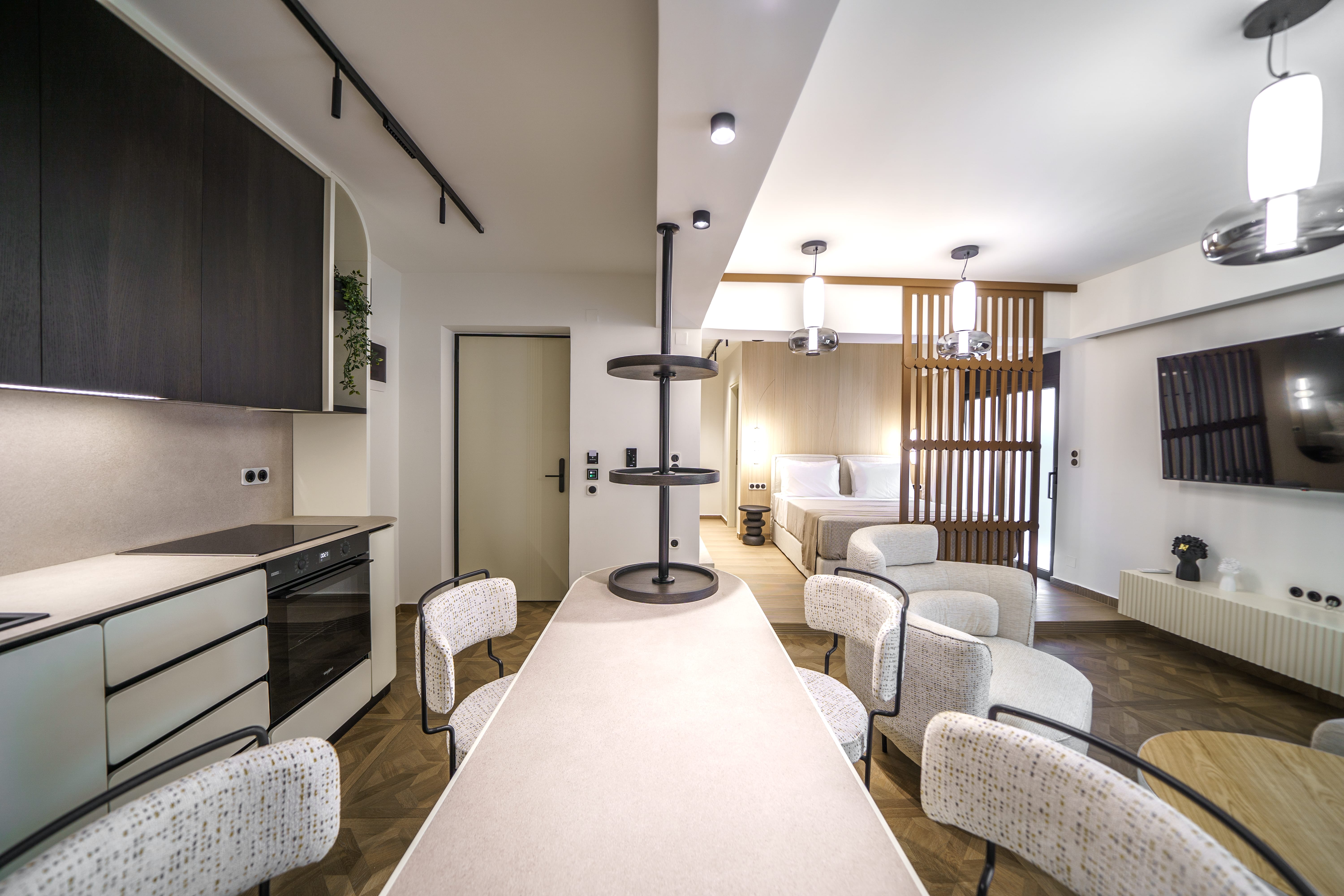 a room with white couches and a bar stool