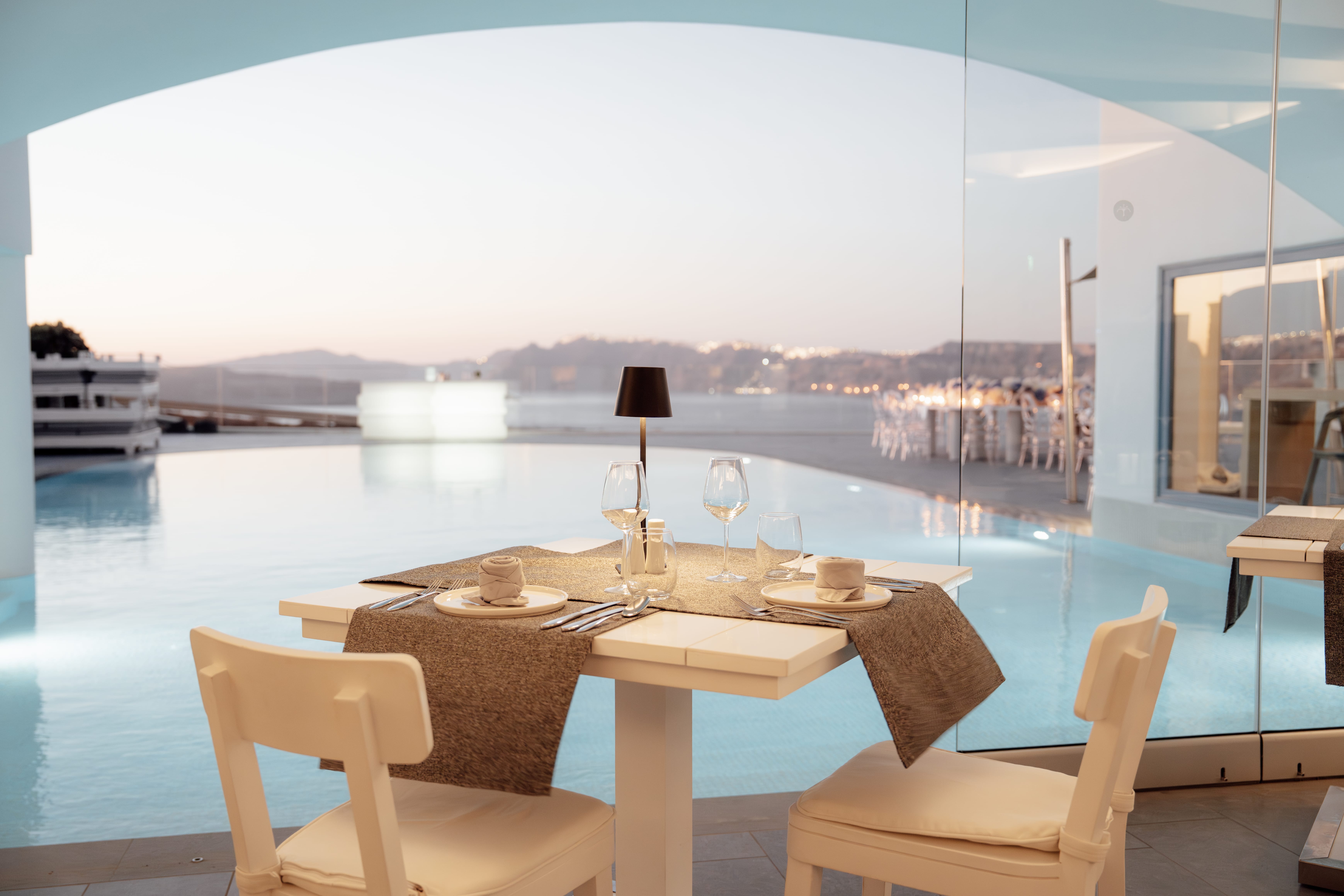 a table with chairs and a view of a city