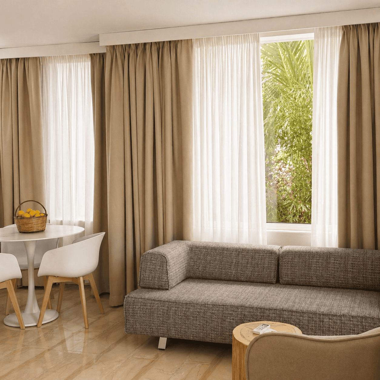 a room with a couch and a table and chairs