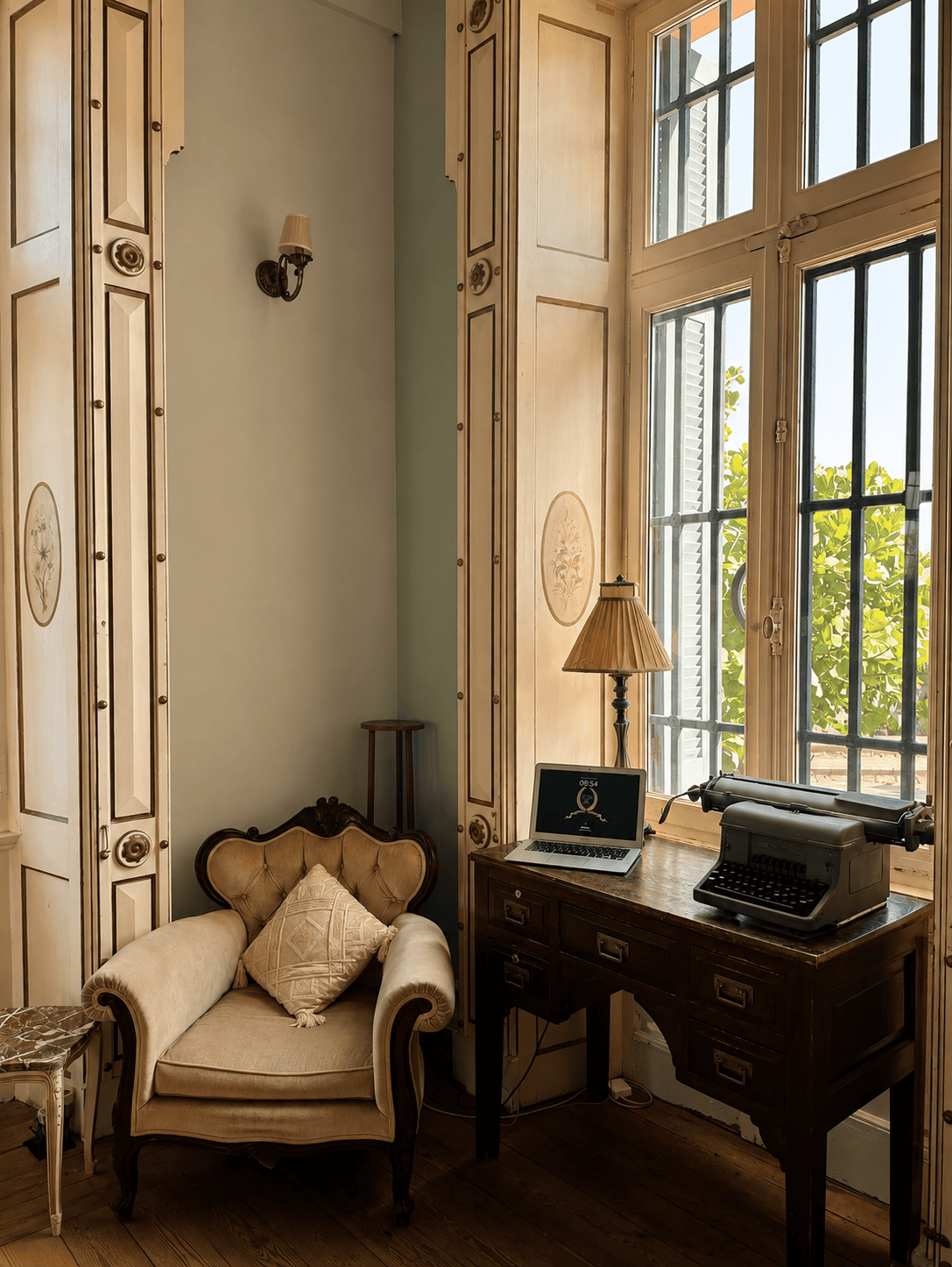 a desk with a laptop and a chair in a room with windows