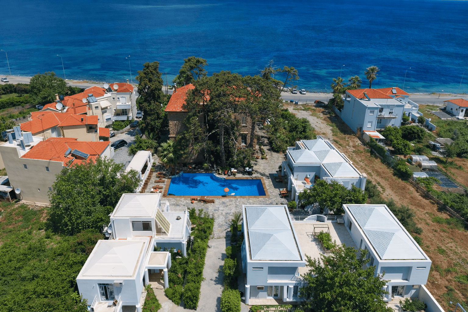 a pool in a pool surrounded by buildings by water