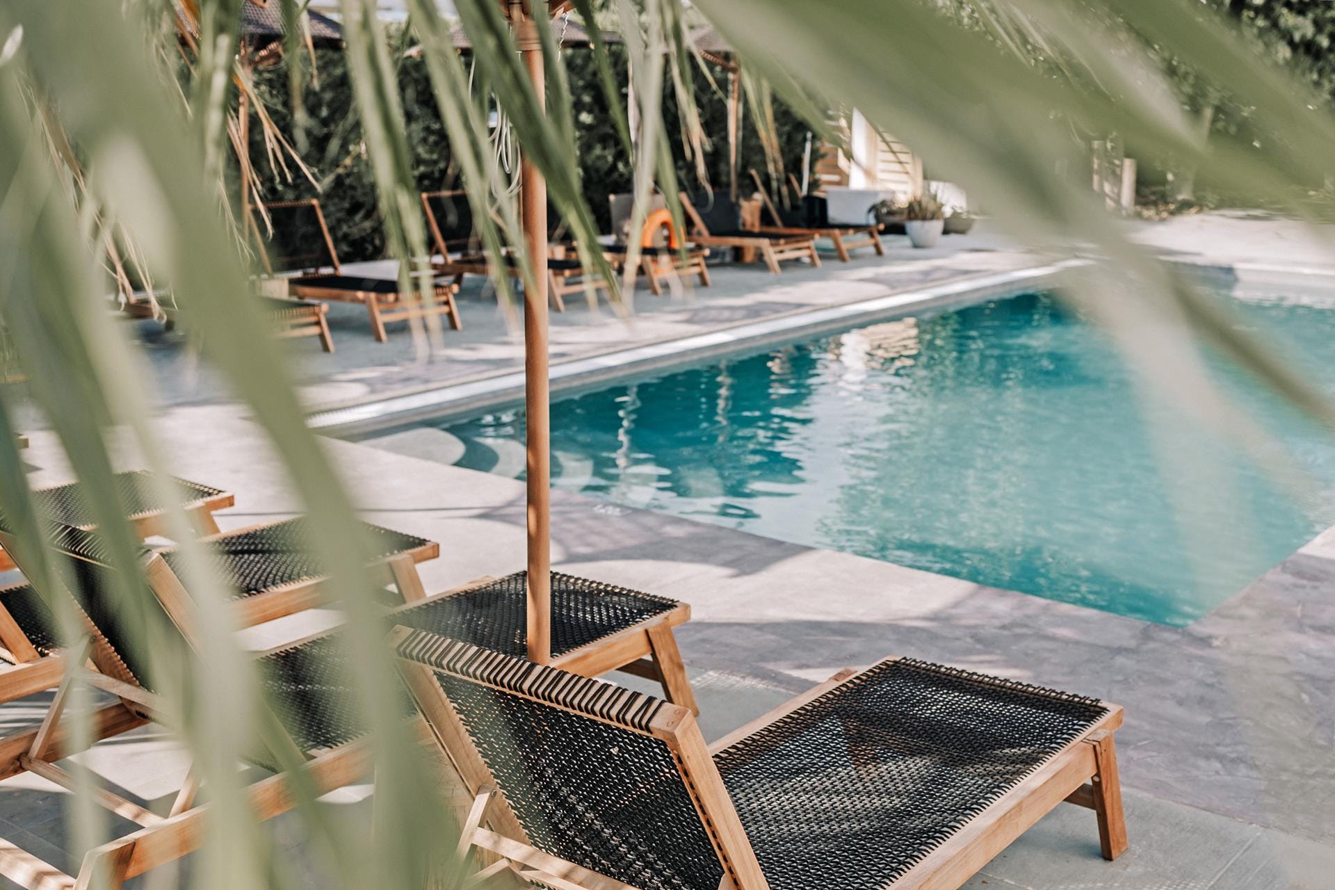 a pool with a deck and chairs