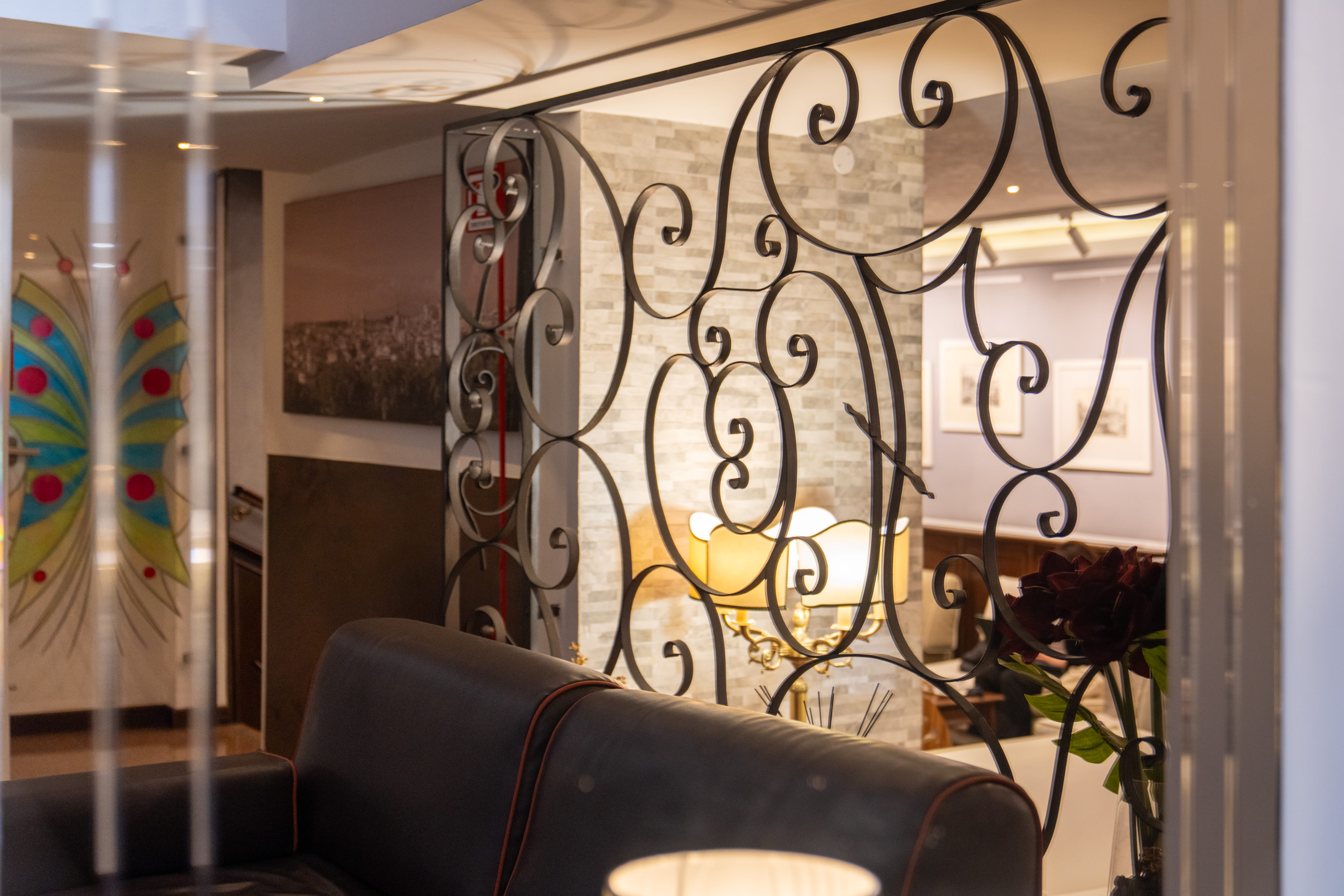 a chair in front of a wall with a decorative design