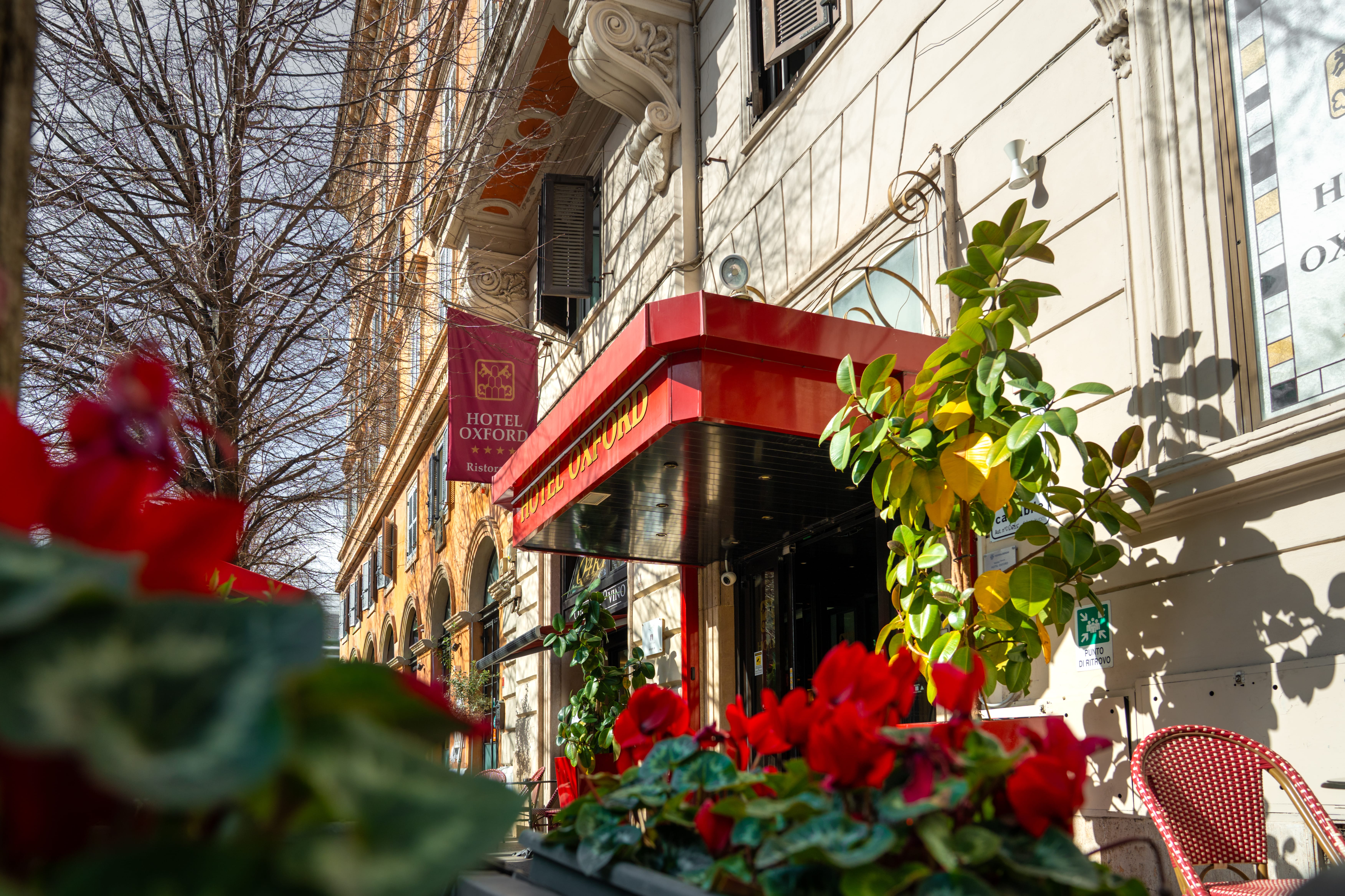 a red flower pot in front of a building