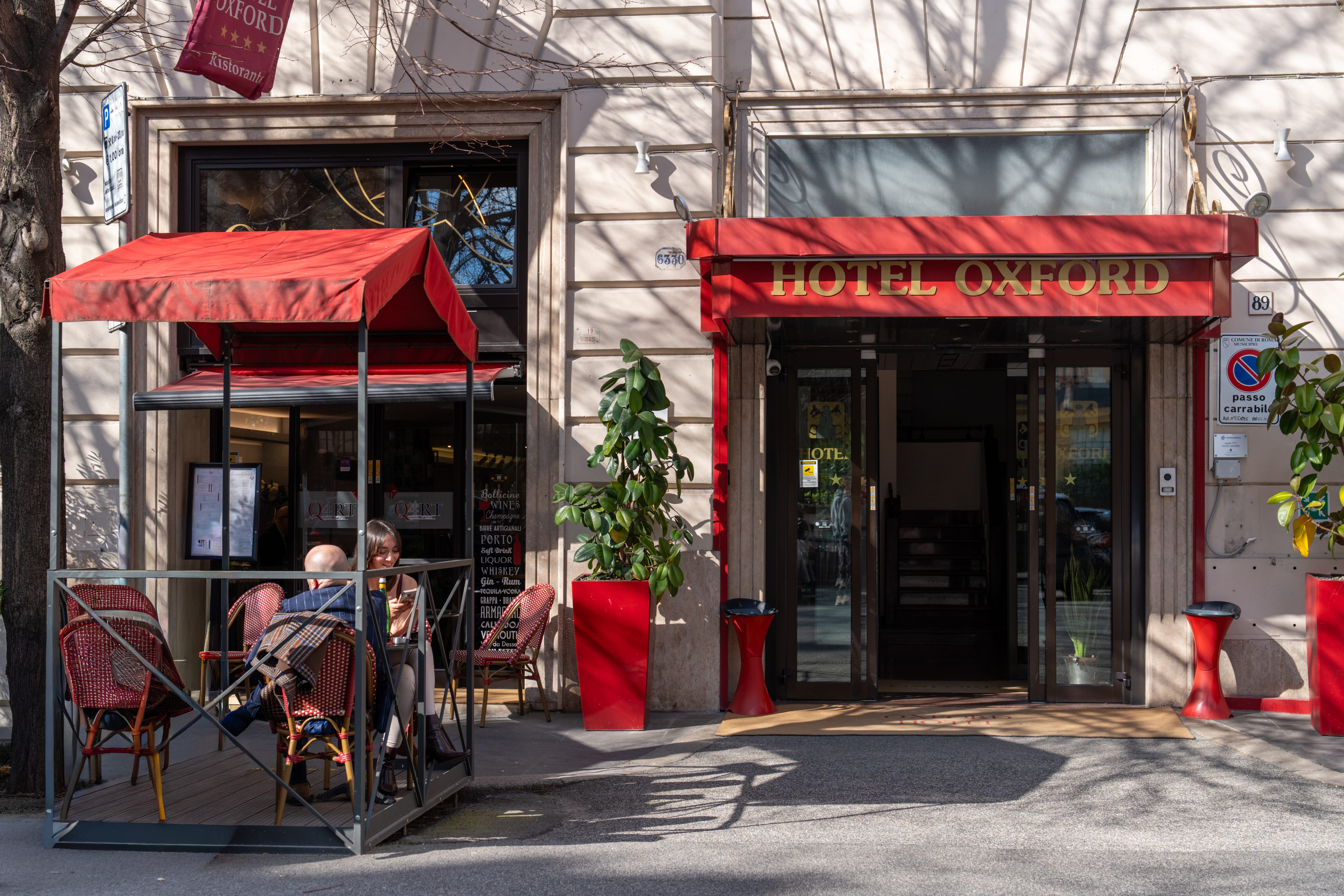 a couple of people sitting at a table outside a restaurant