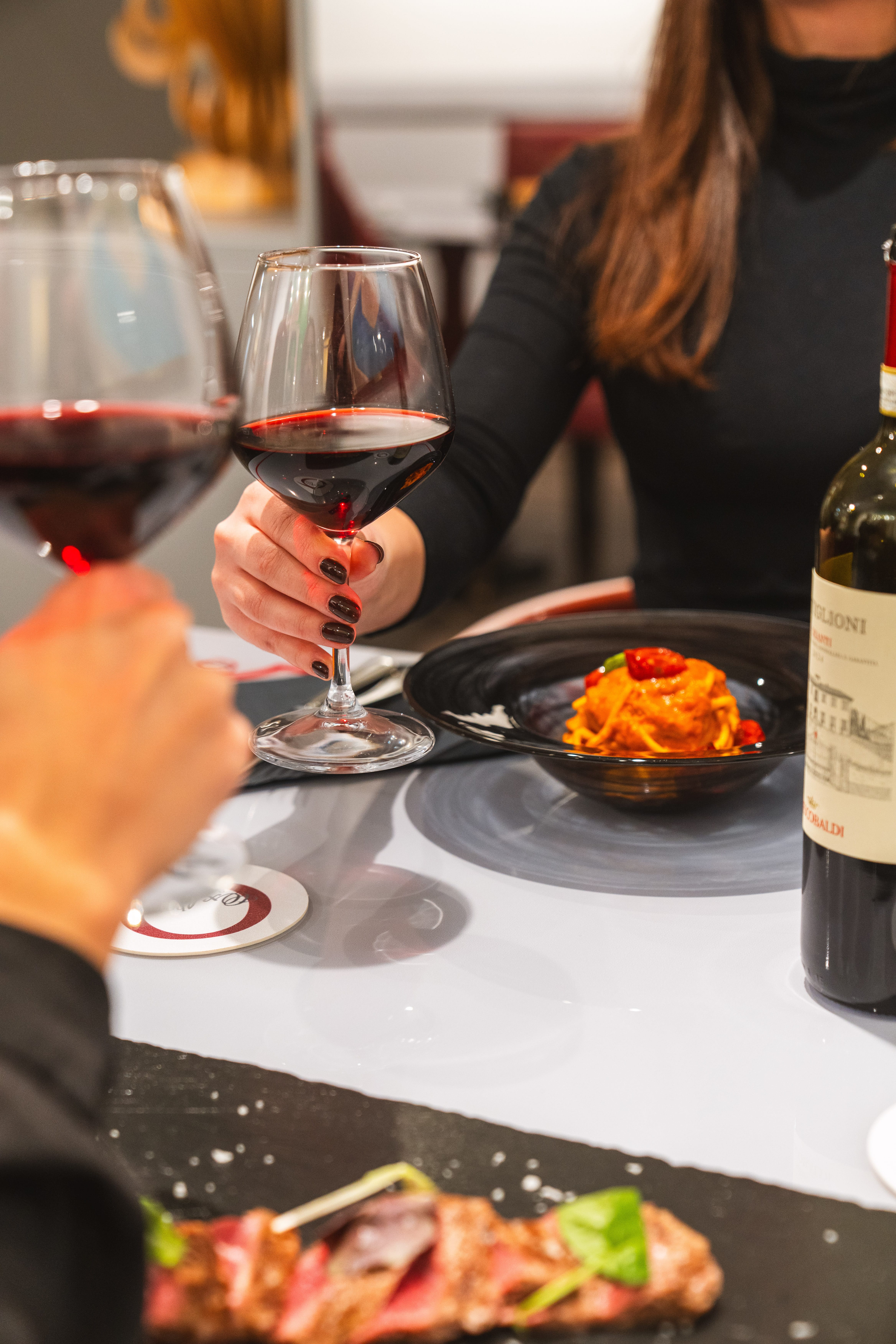 a couple of people holding wine glasses