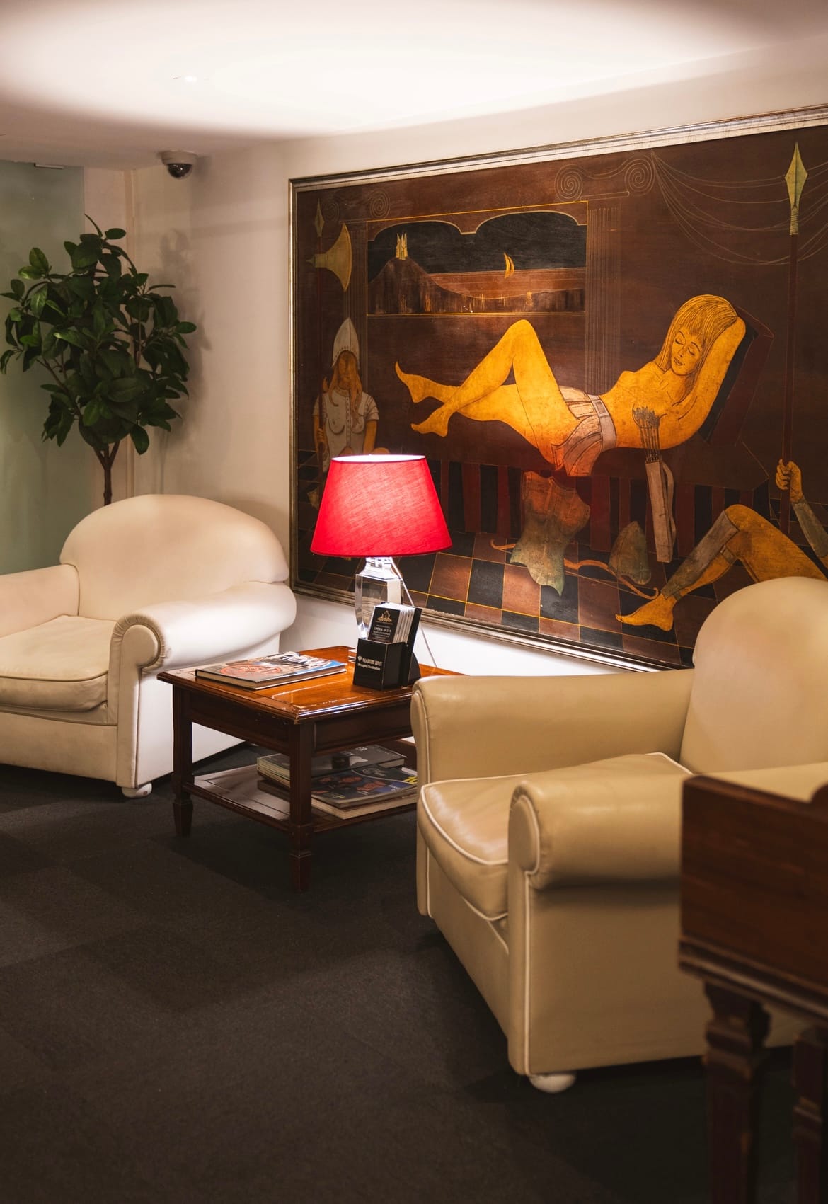 a living room with a painting on the wall