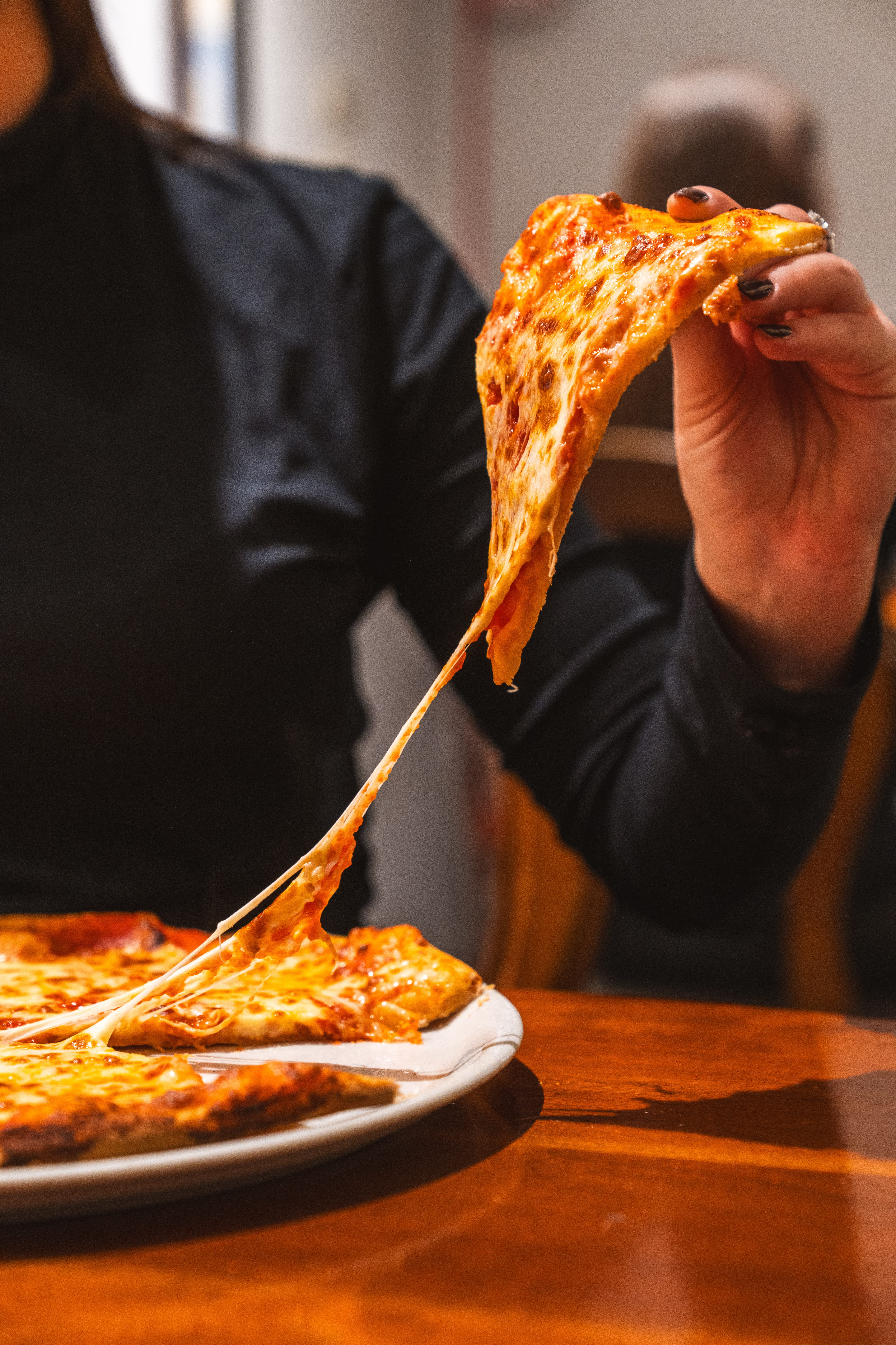 a person eating a slice of pizza