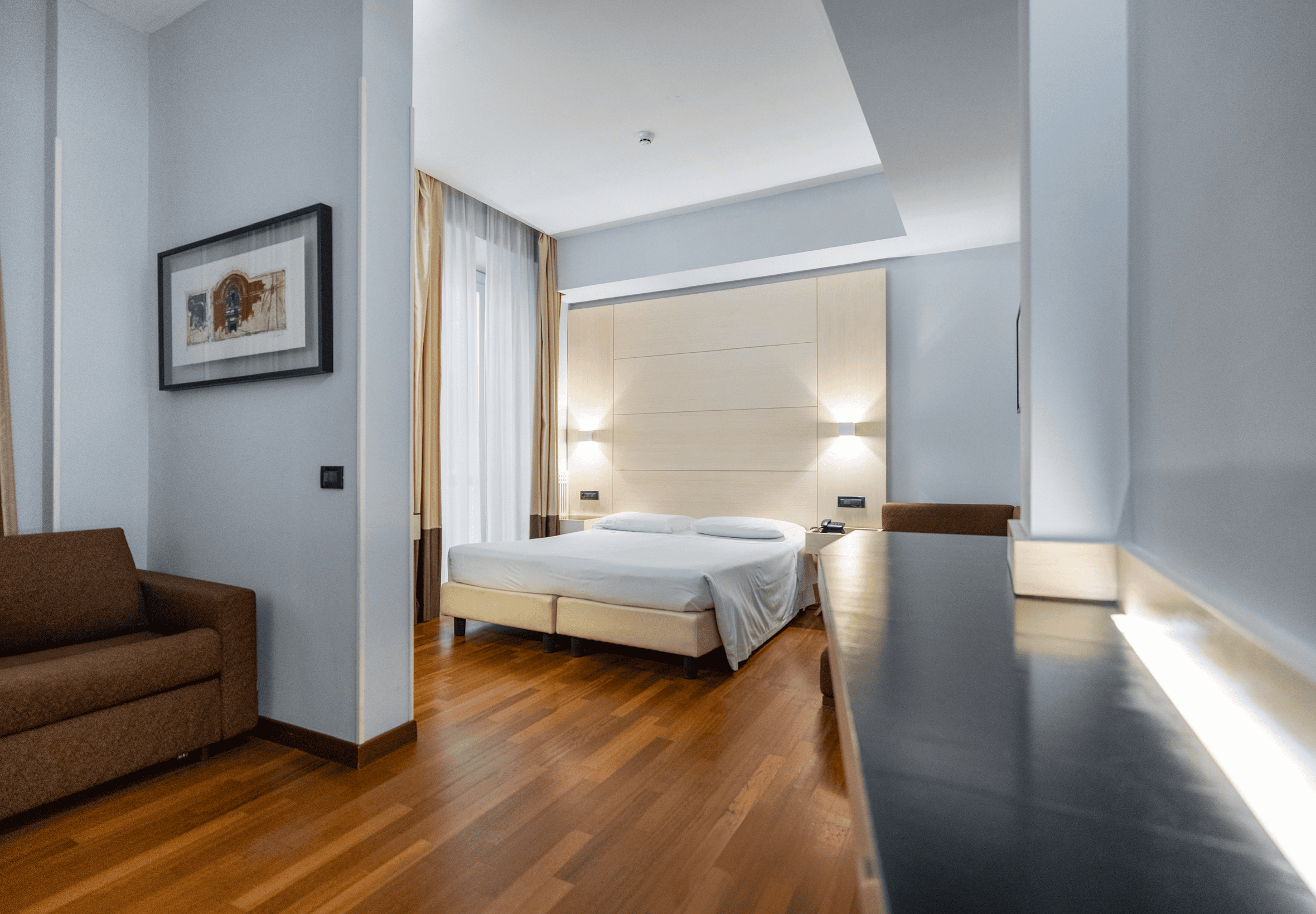 a bedroom with a bed and a couch