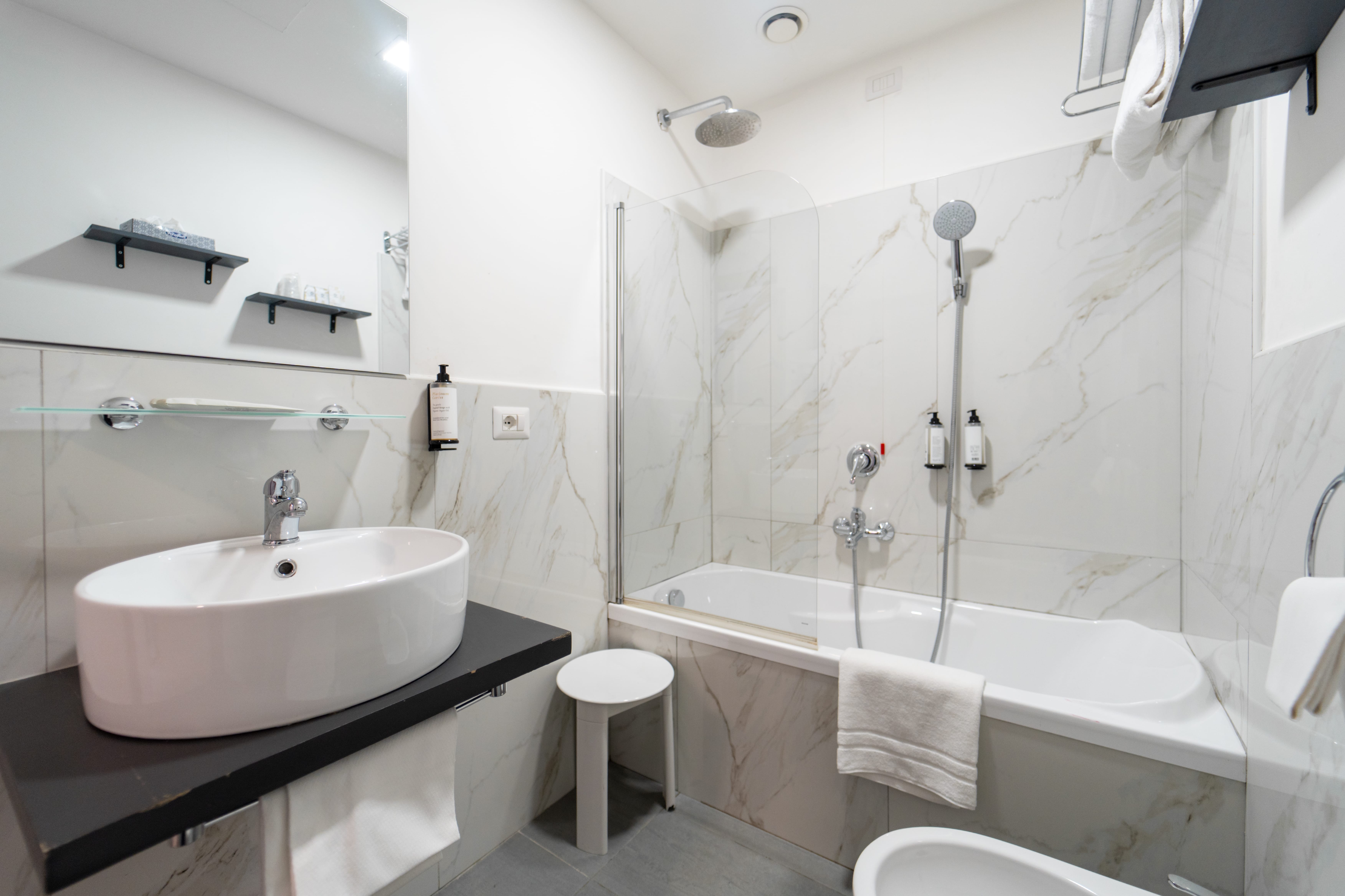 a bathroom with a tub sink and toilet