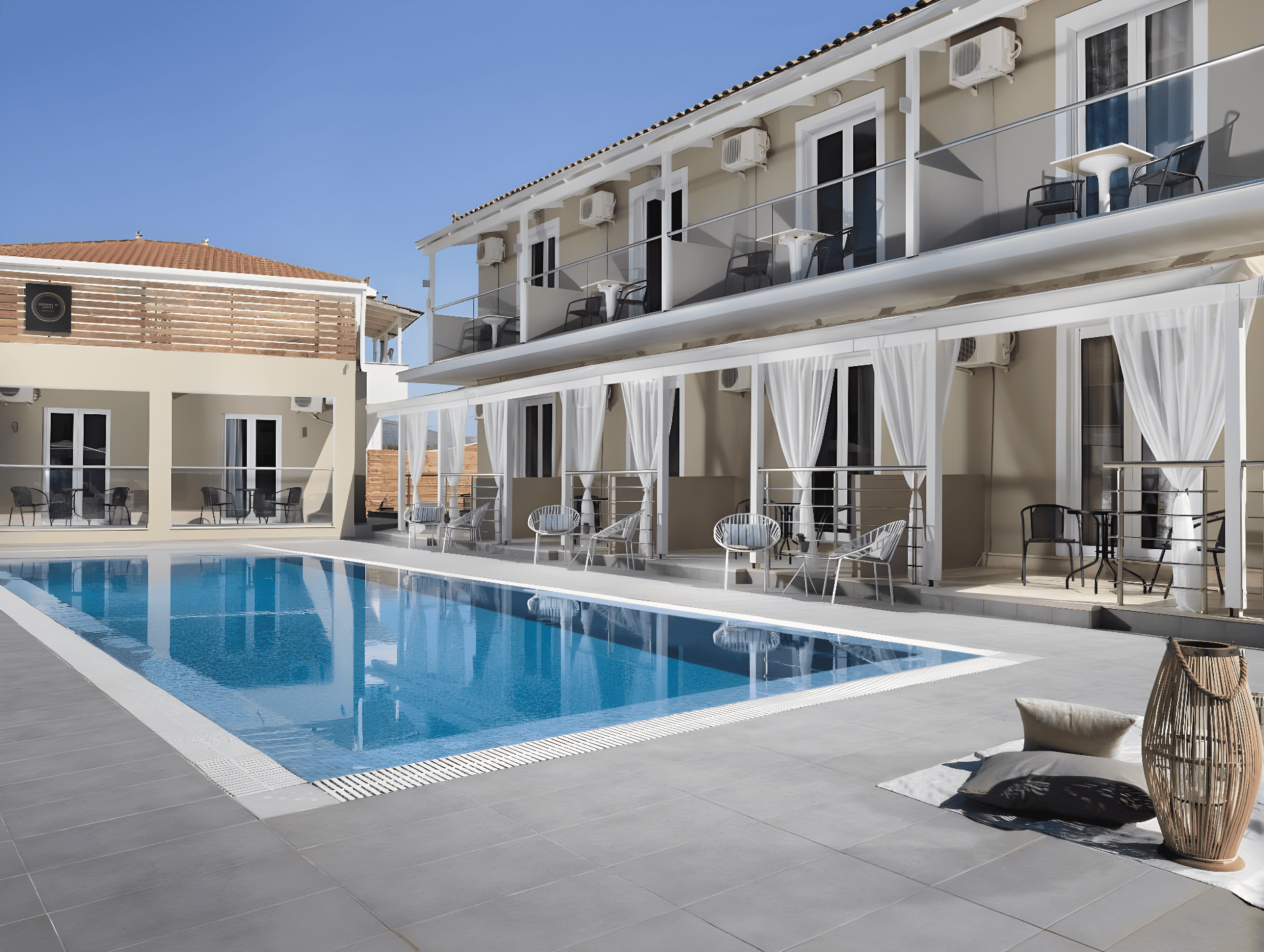 a swimming pool in front of a white building