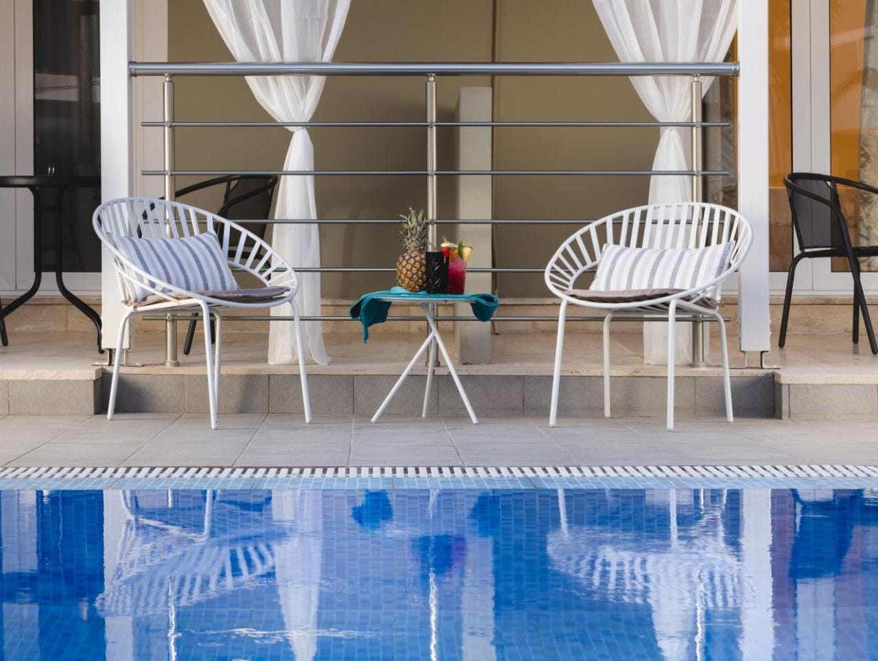a pool with chairs around it