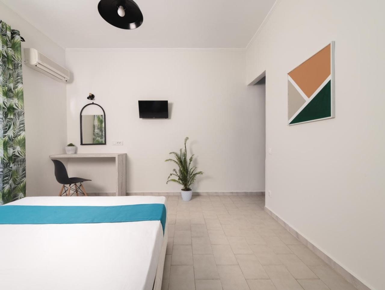 a room with a pool table and a plant
