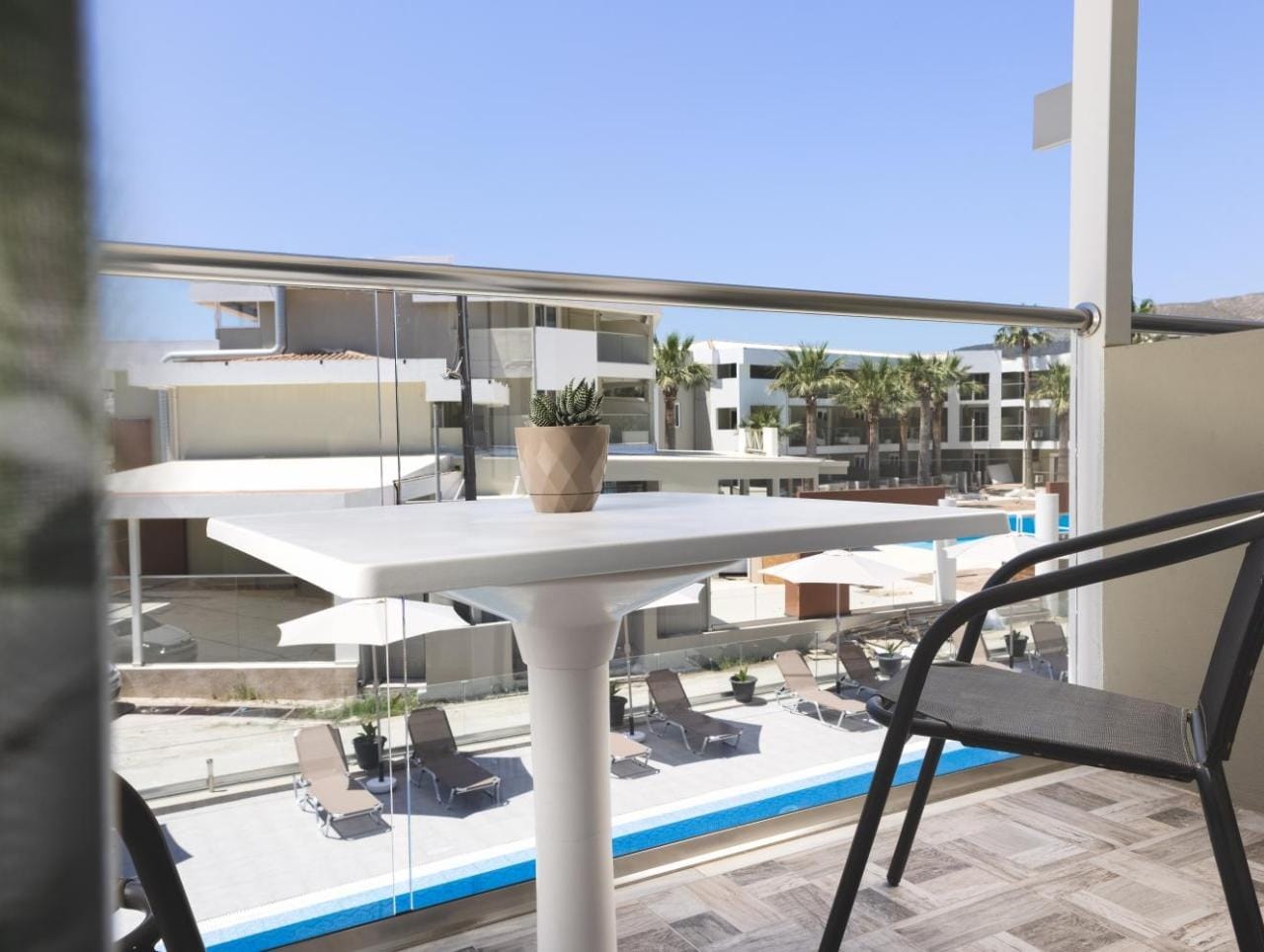 a pool with a deck and chairs