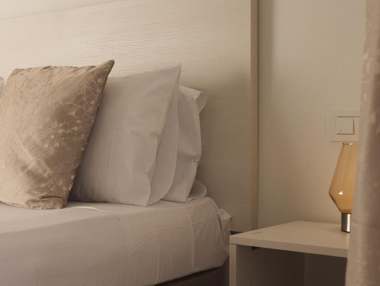 a white bed with pillows