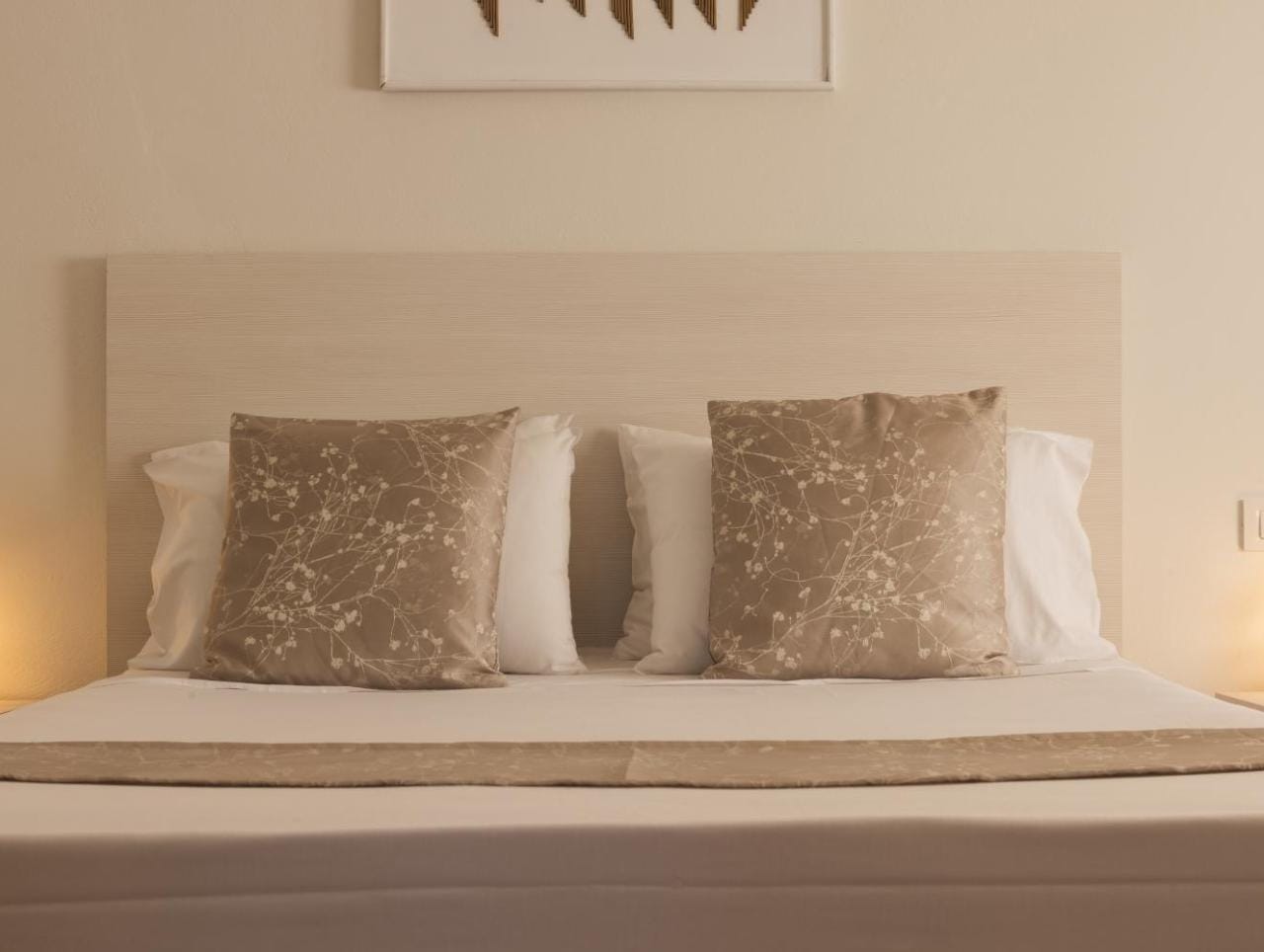 a white bed with pillows