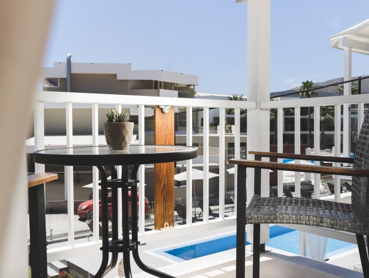 a balcony with a pool and a building in the background