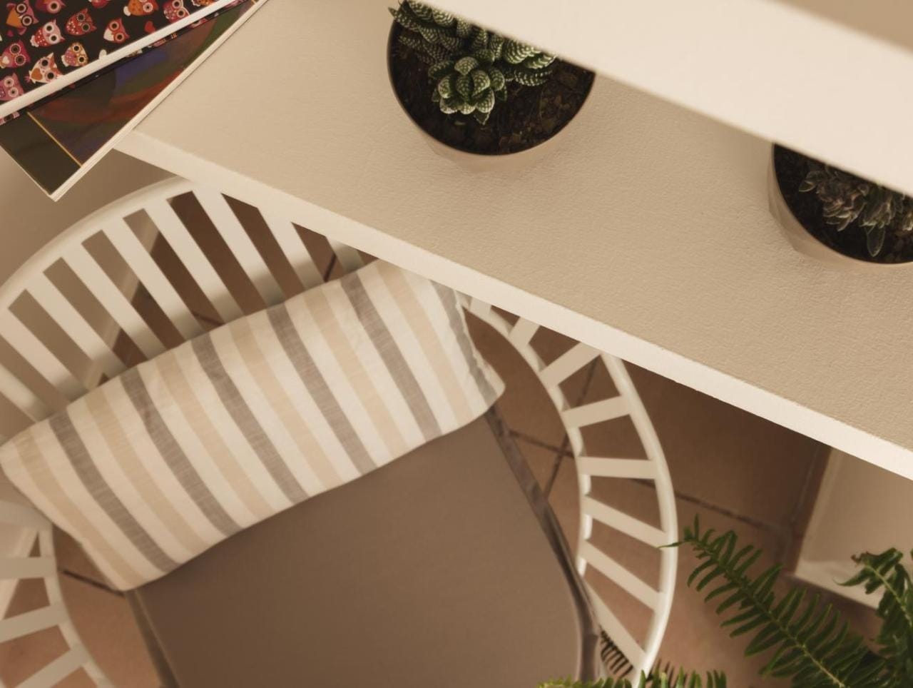 a white chair with a plant on it
