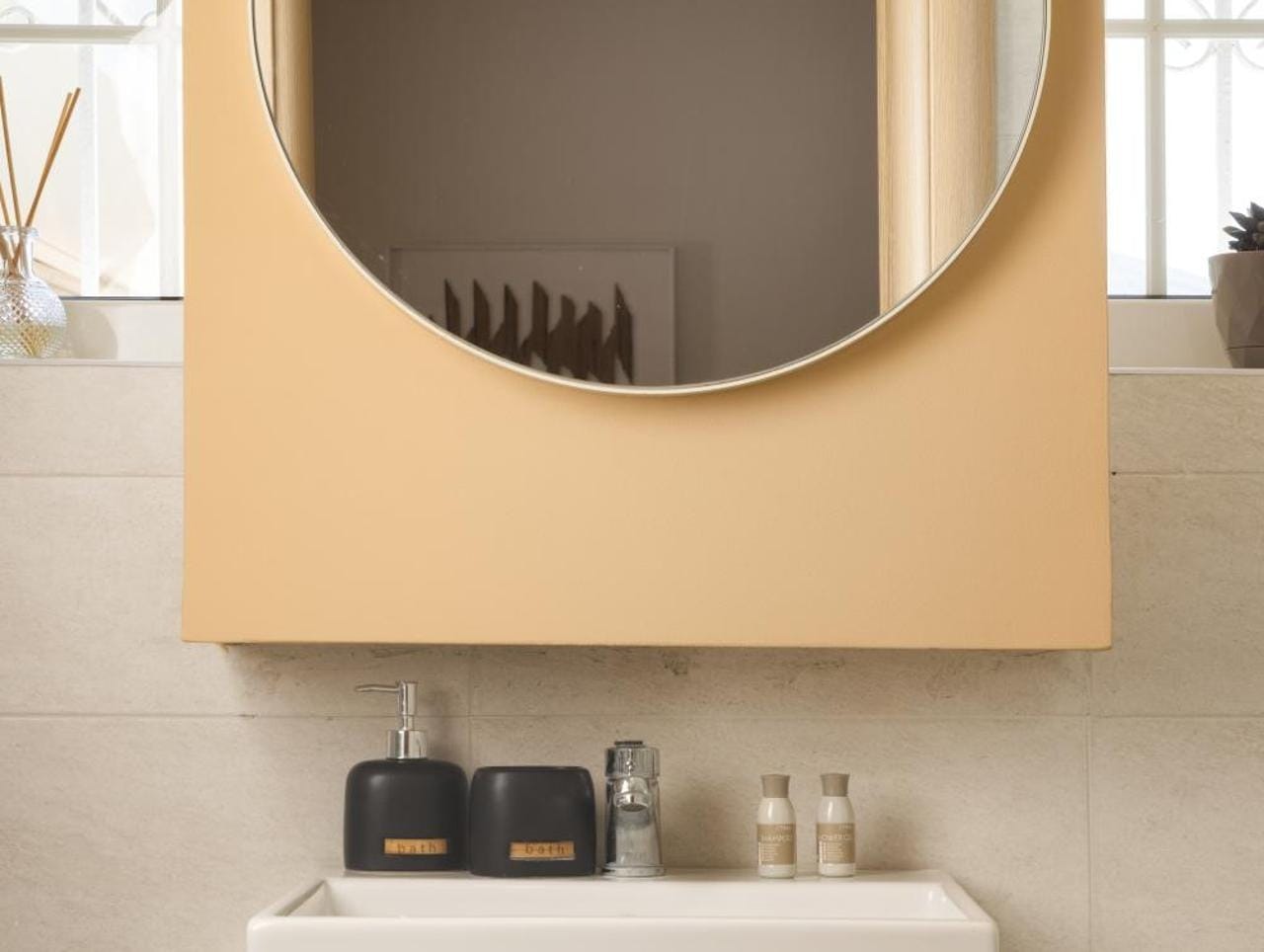 a mirror above a sink