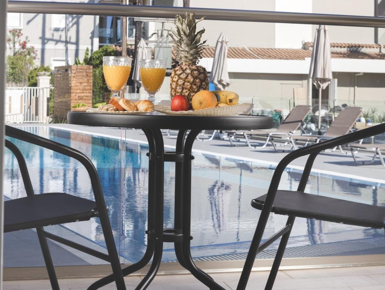 a table with chairs and a table with fruit on it