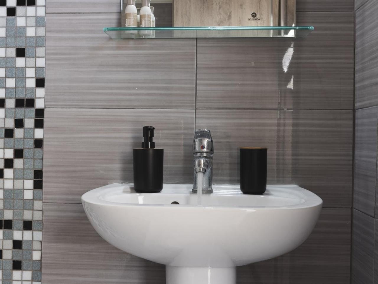 a sink with a mirror above it
