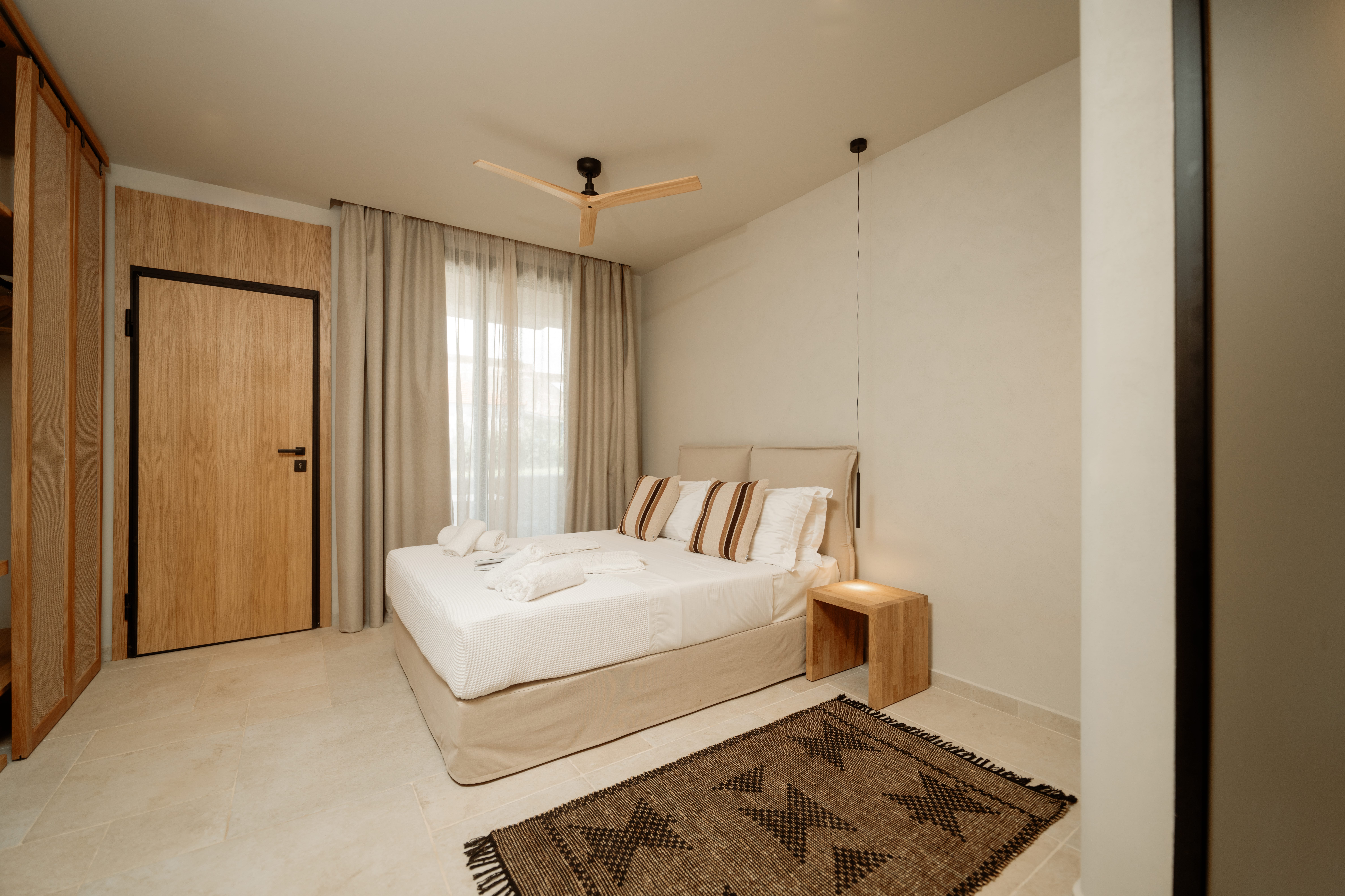 a bedroom with a bed and a fan
