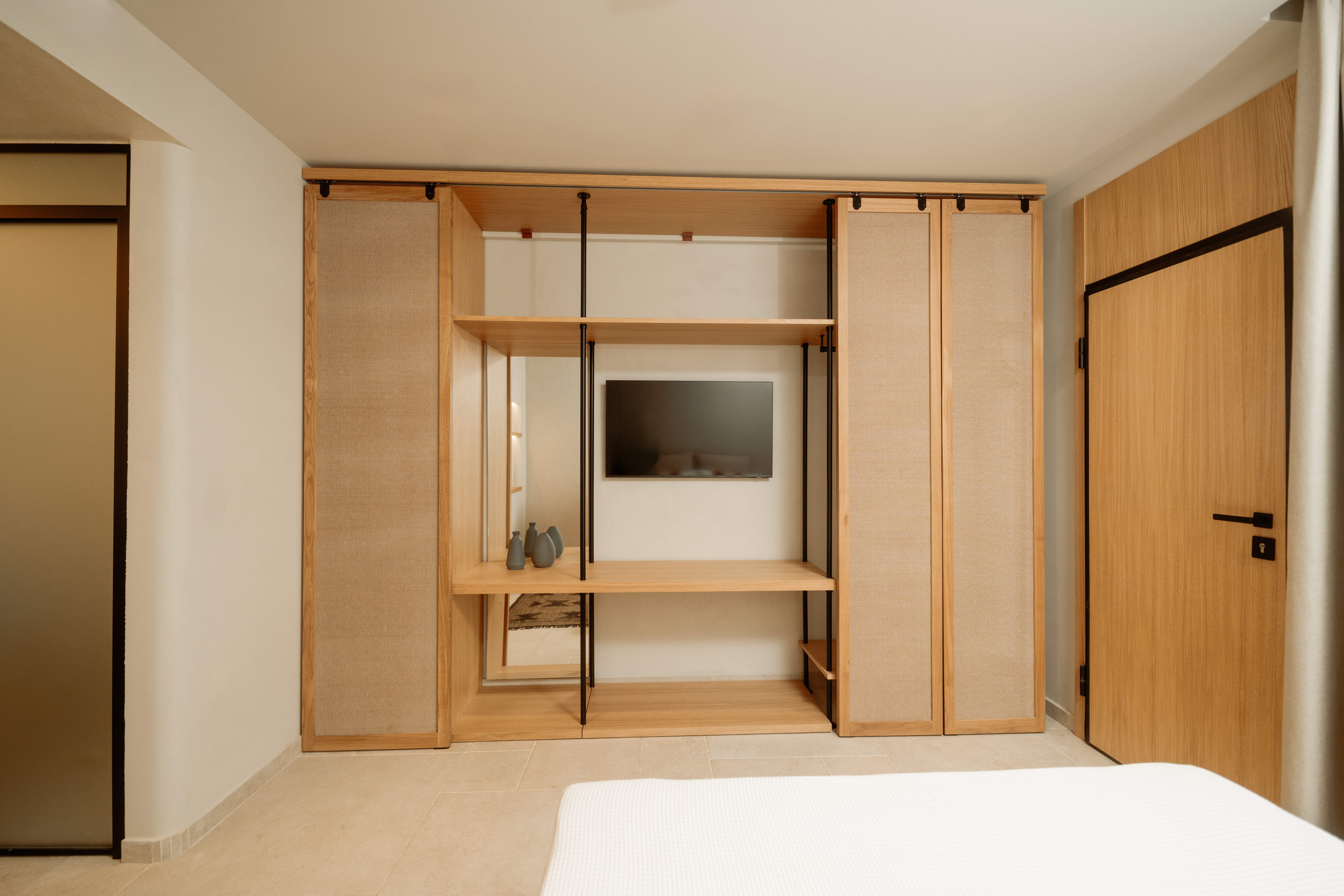 a room with a tv and a shelf