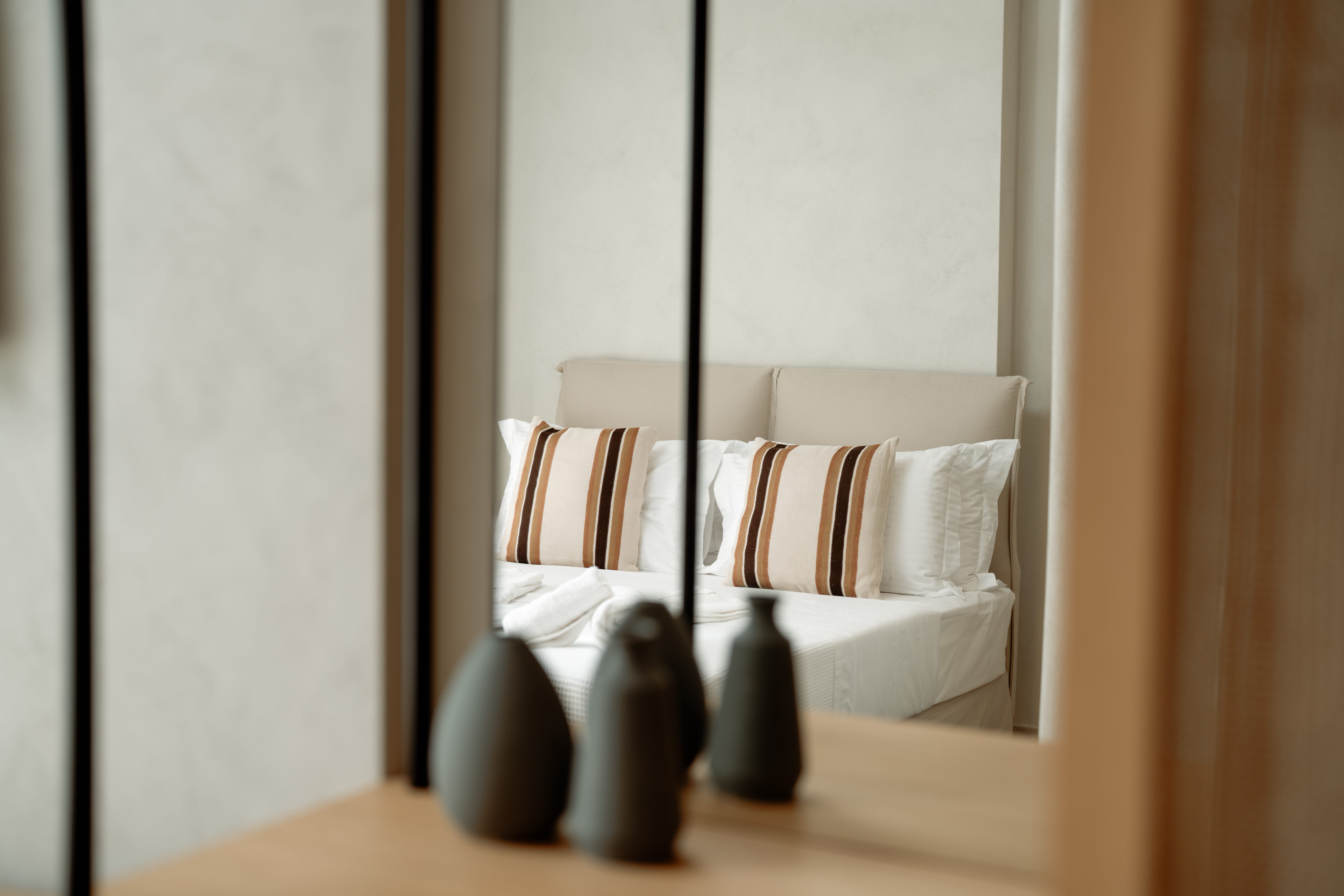 a bed with a vase and a vase on the side