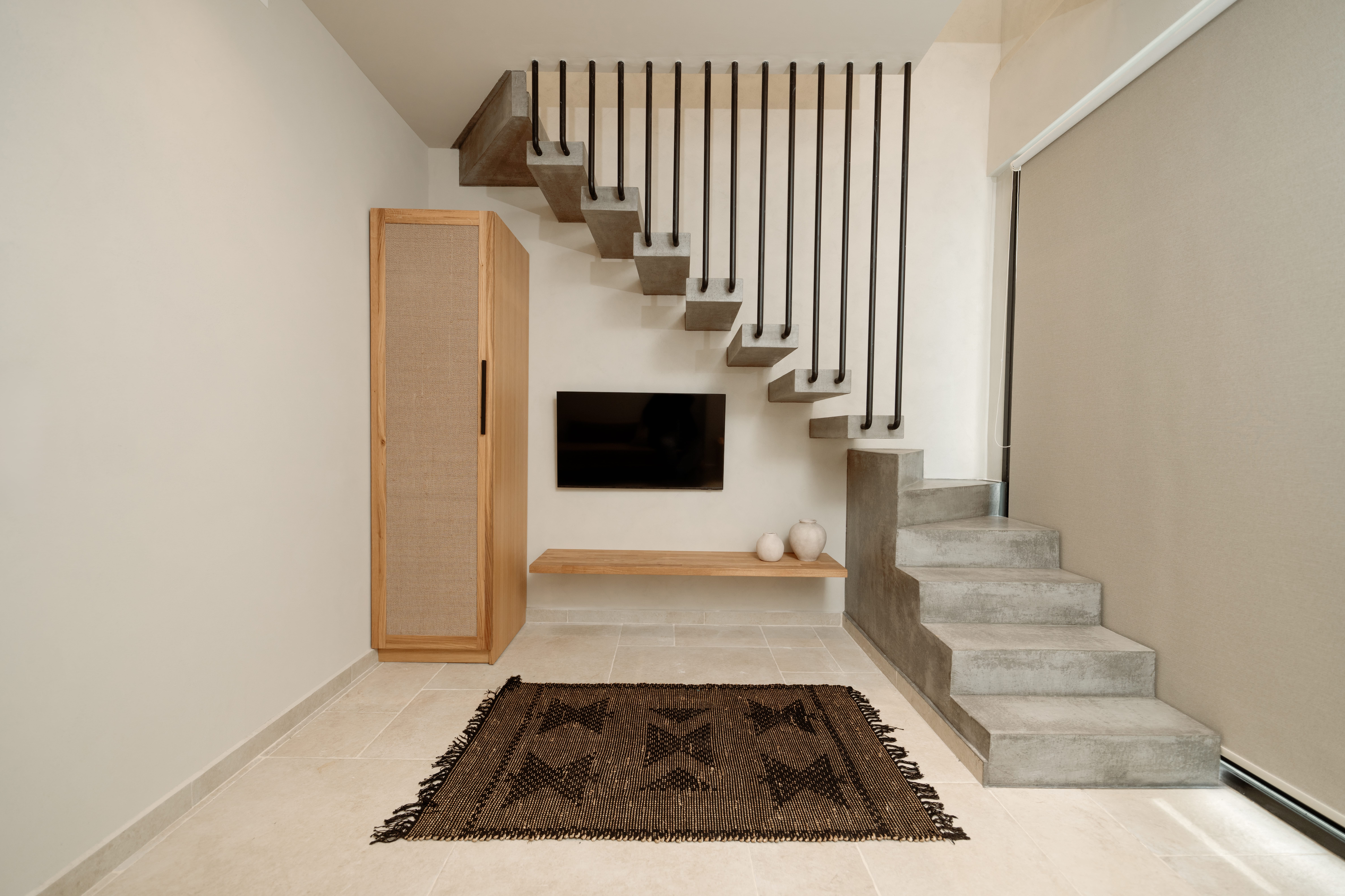 a staircase with a rug and a fireplace
