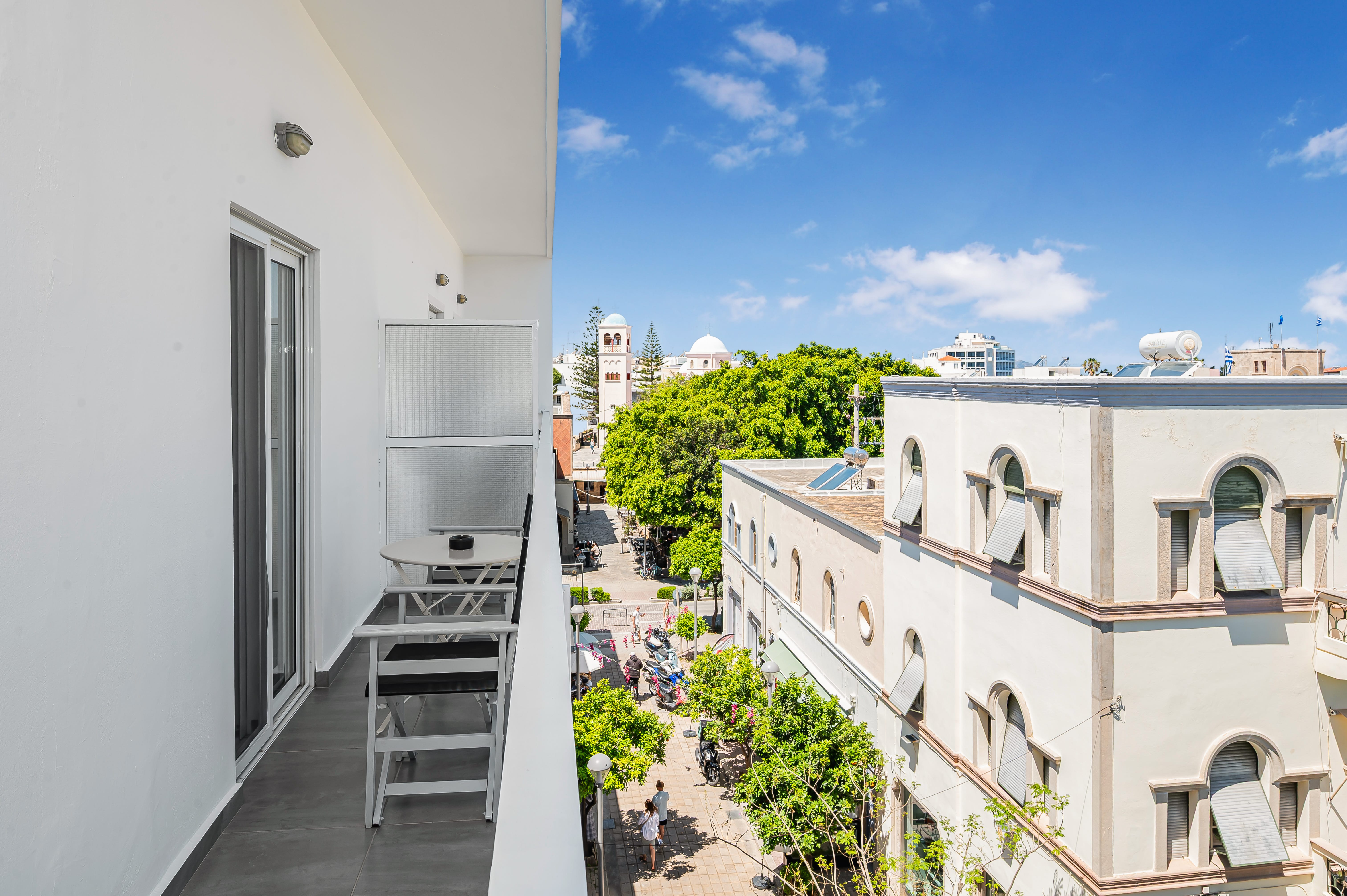 a balcony with a table and chairs on it