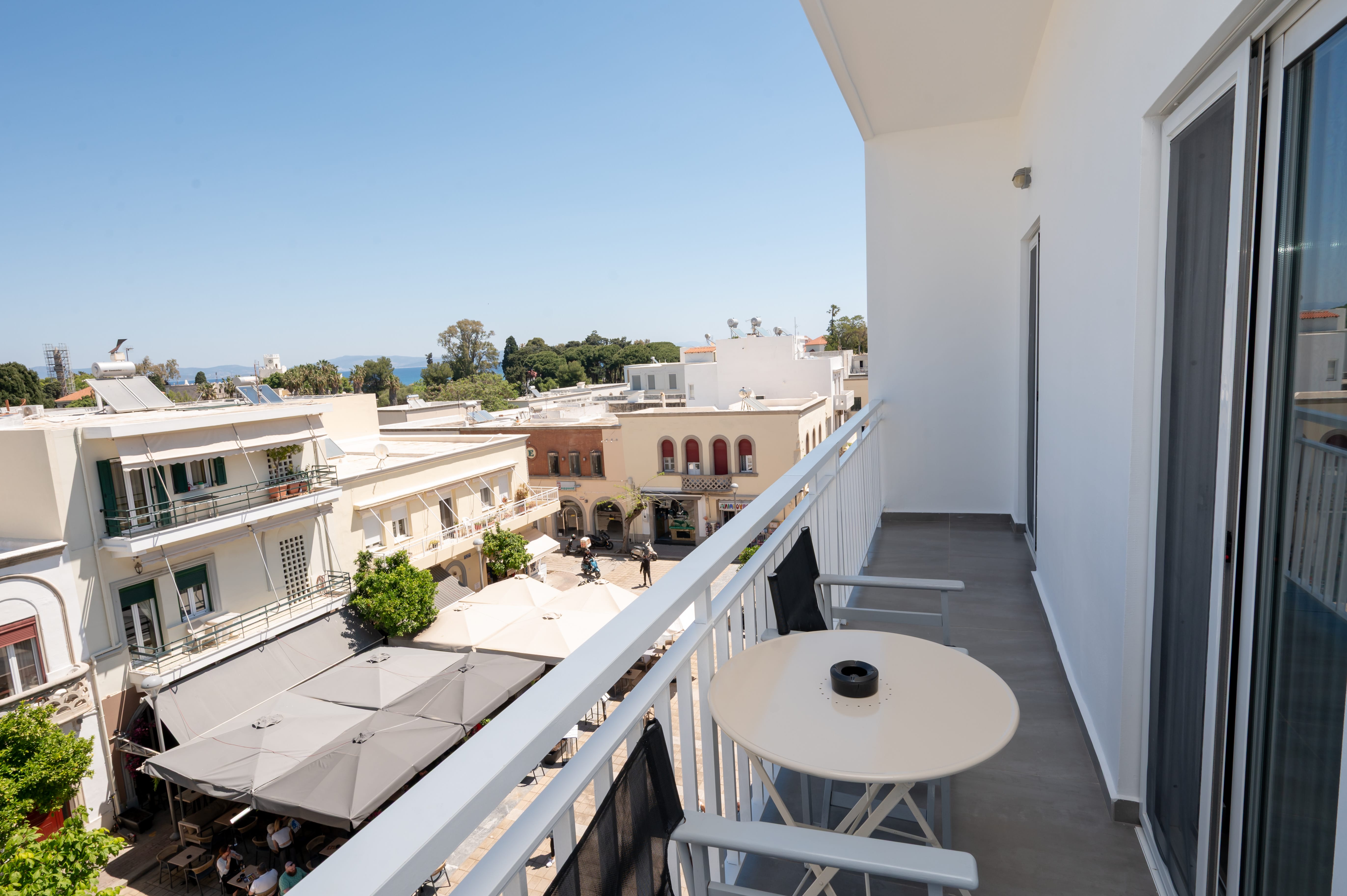 a balcony with a table and chairs