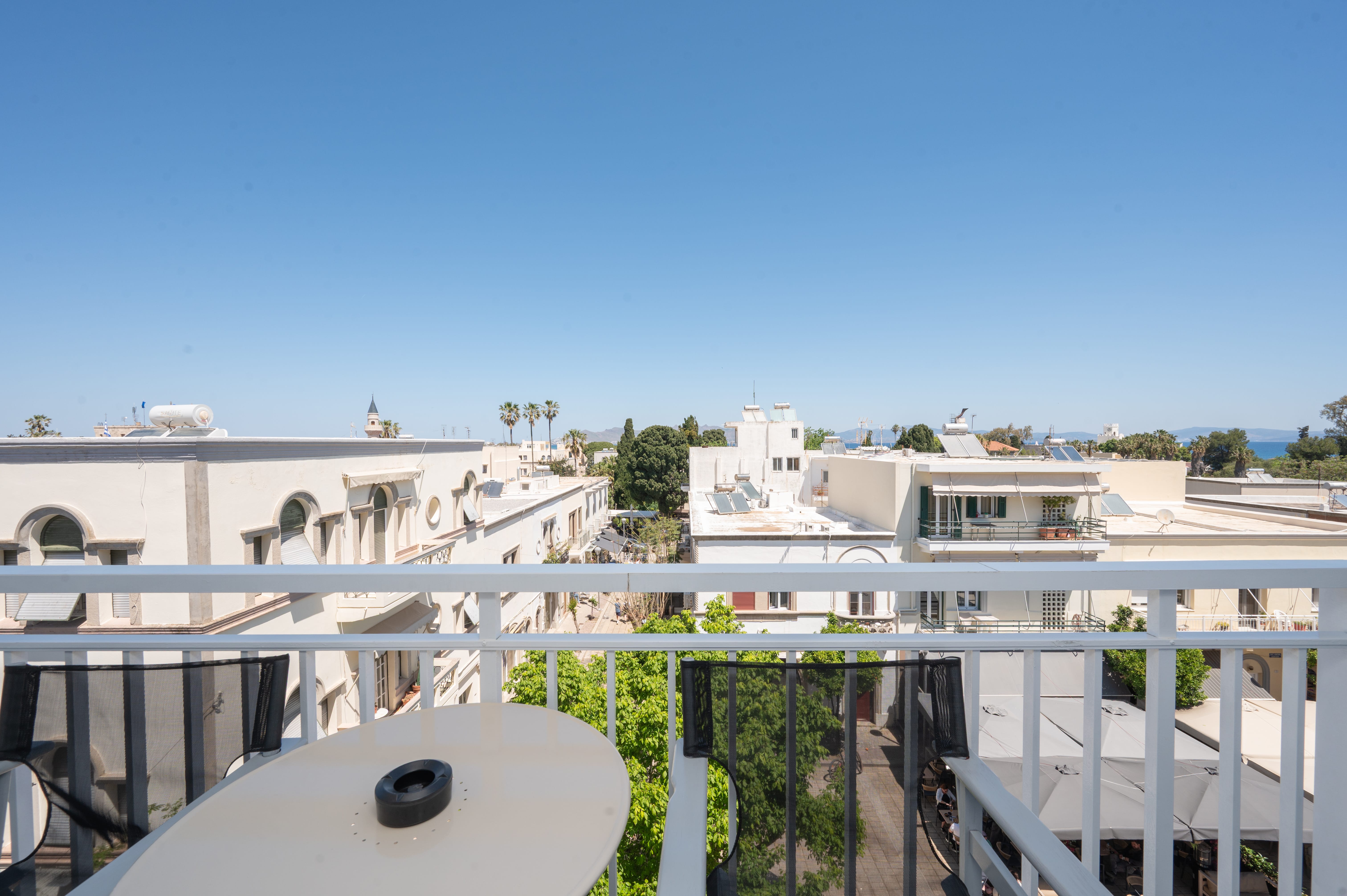 a balcony with a table and chairs