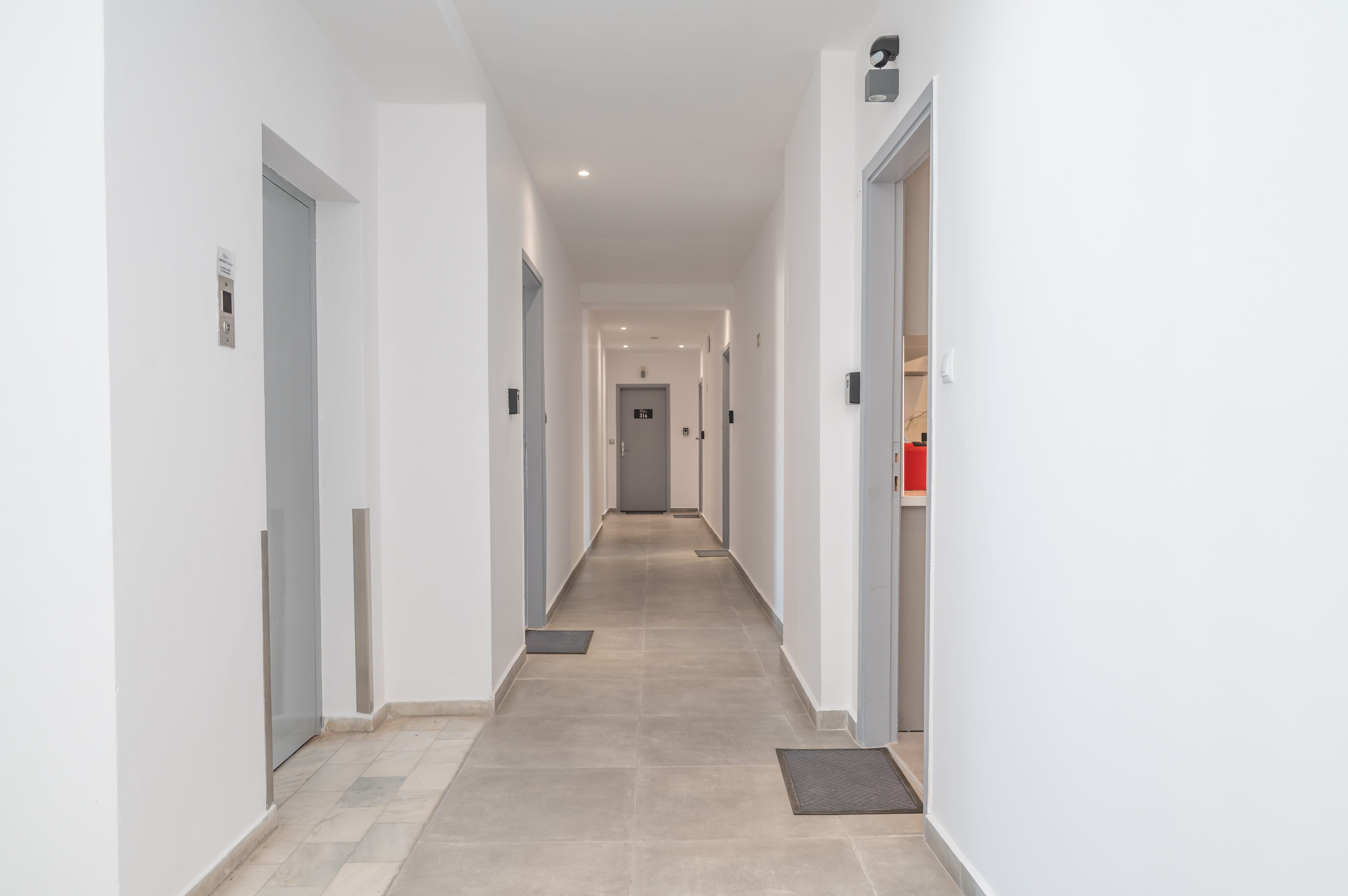 a hallway with white walls and doors