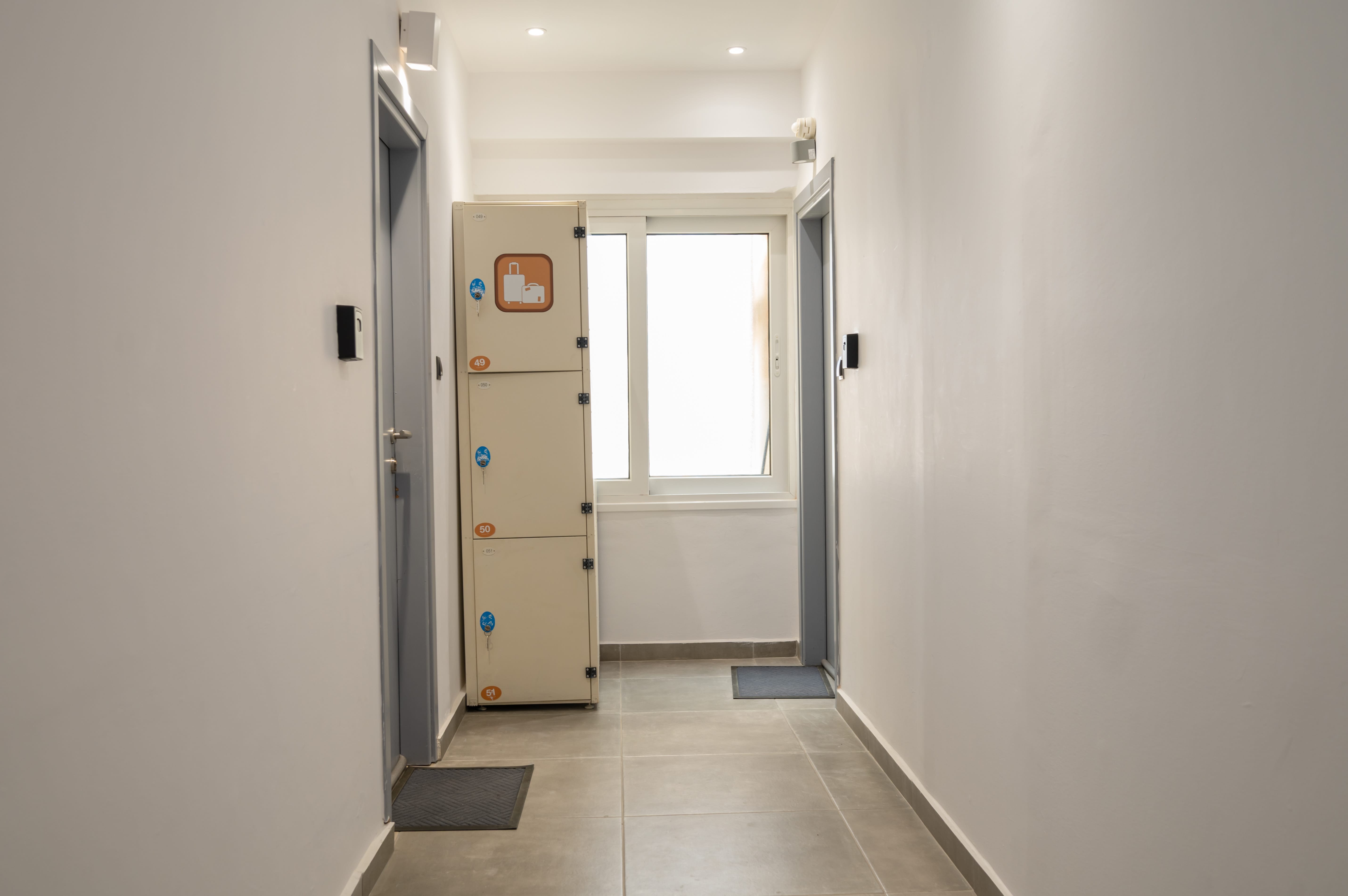 a hallway with a door and a white door