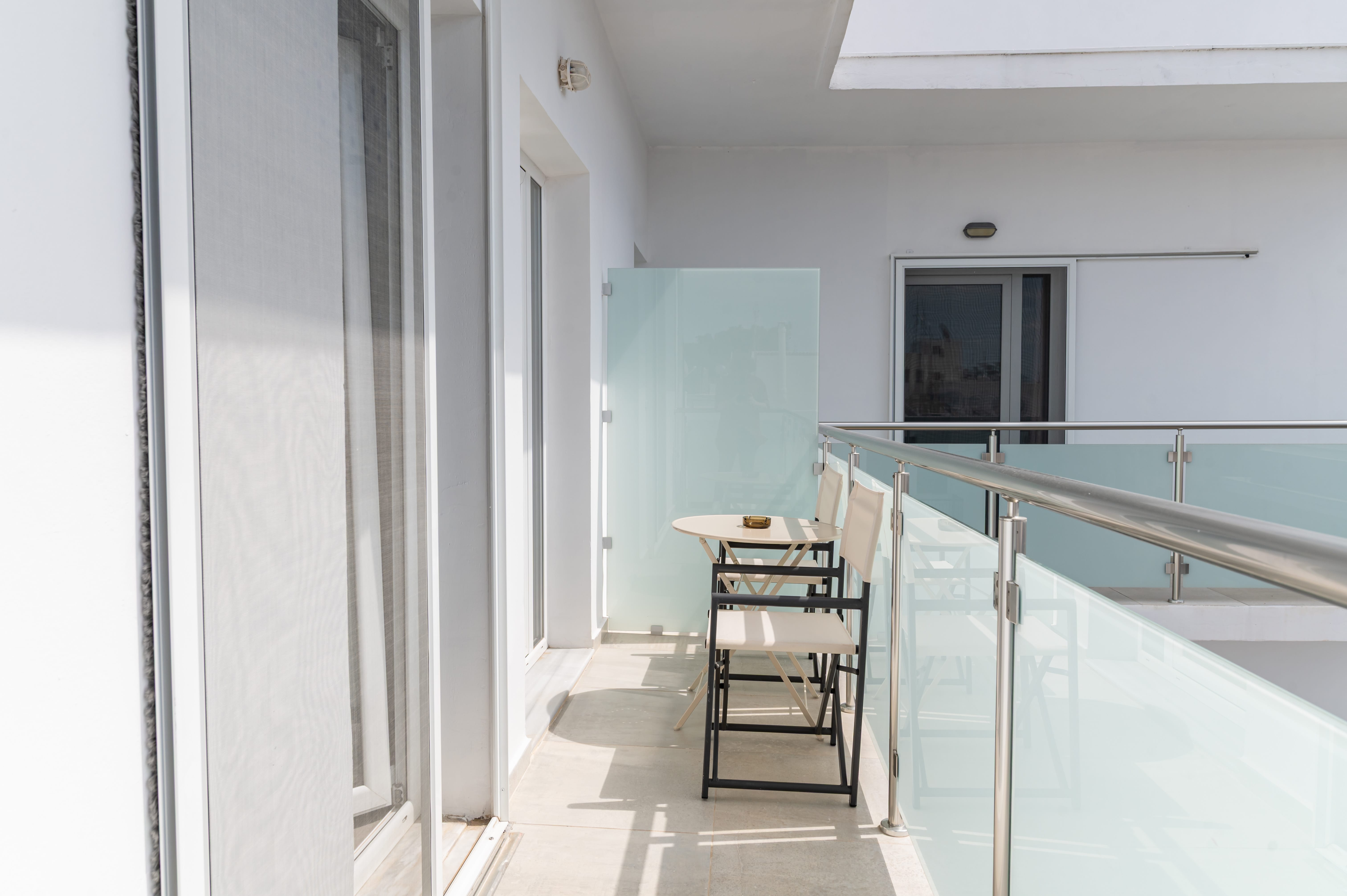 a table and chairs on a balcony