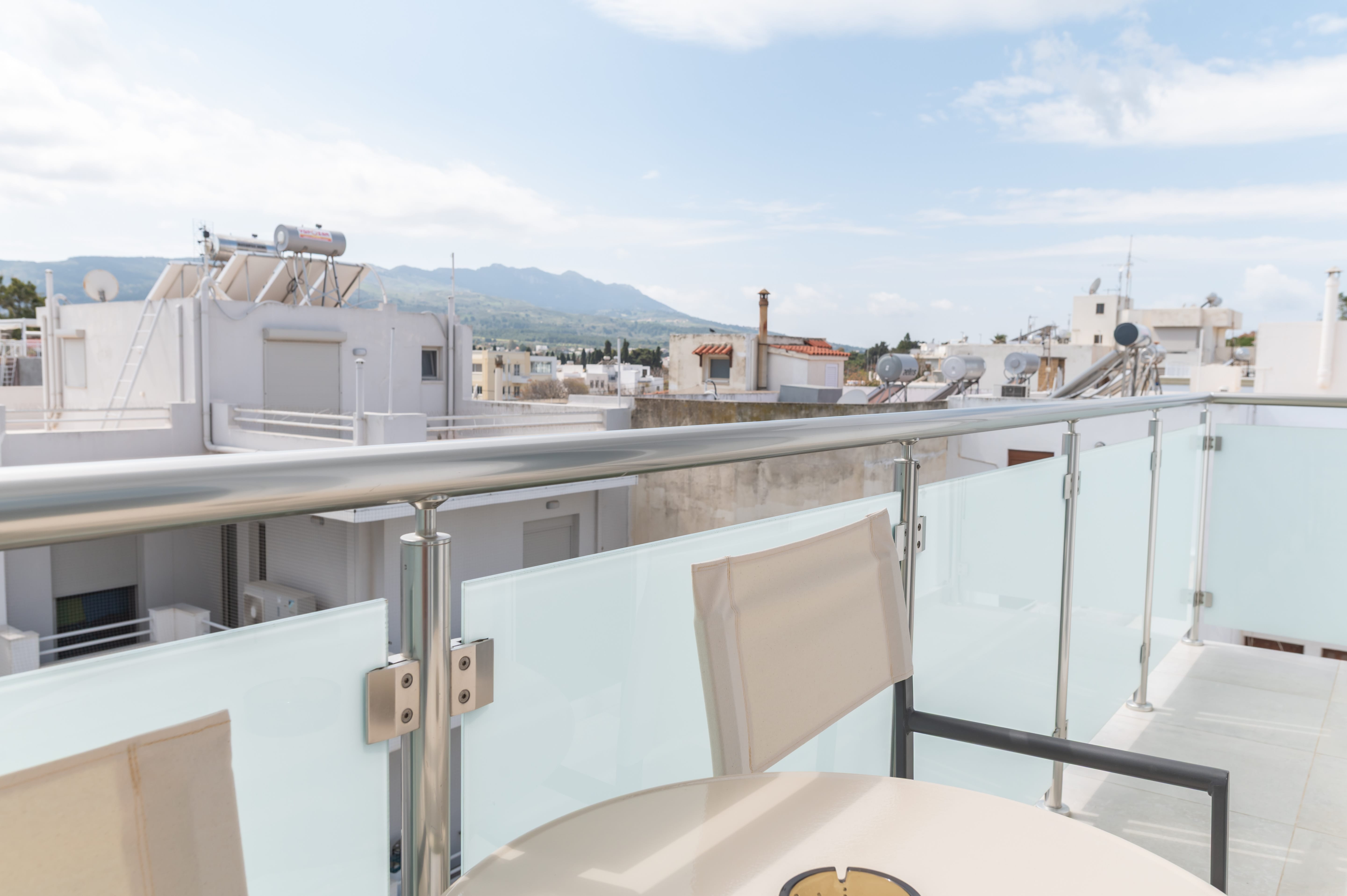 a balcony with a table and chairs