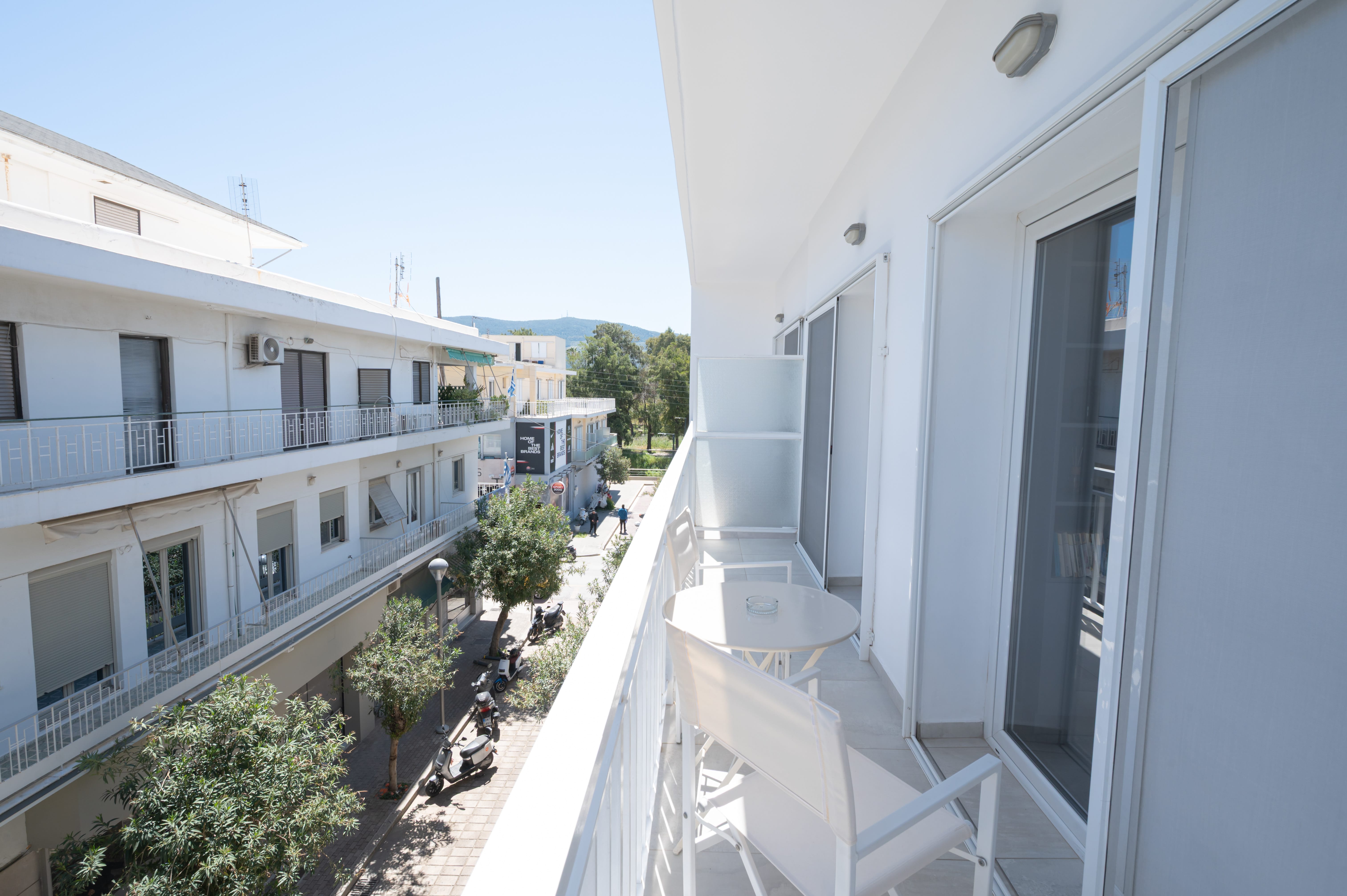 a balcony with a table and chairs
