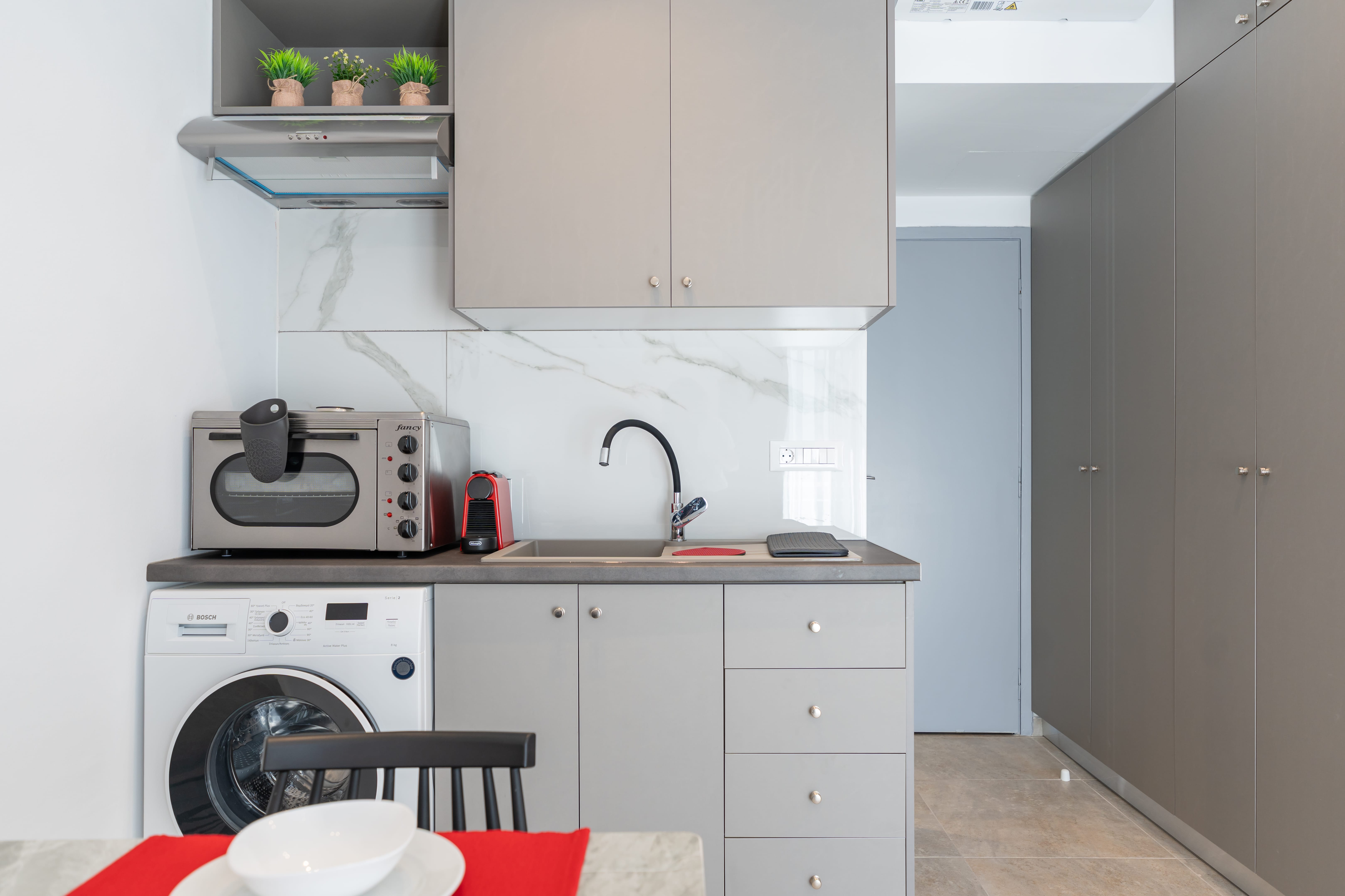 a kitchen with grey cabinets and a microwave