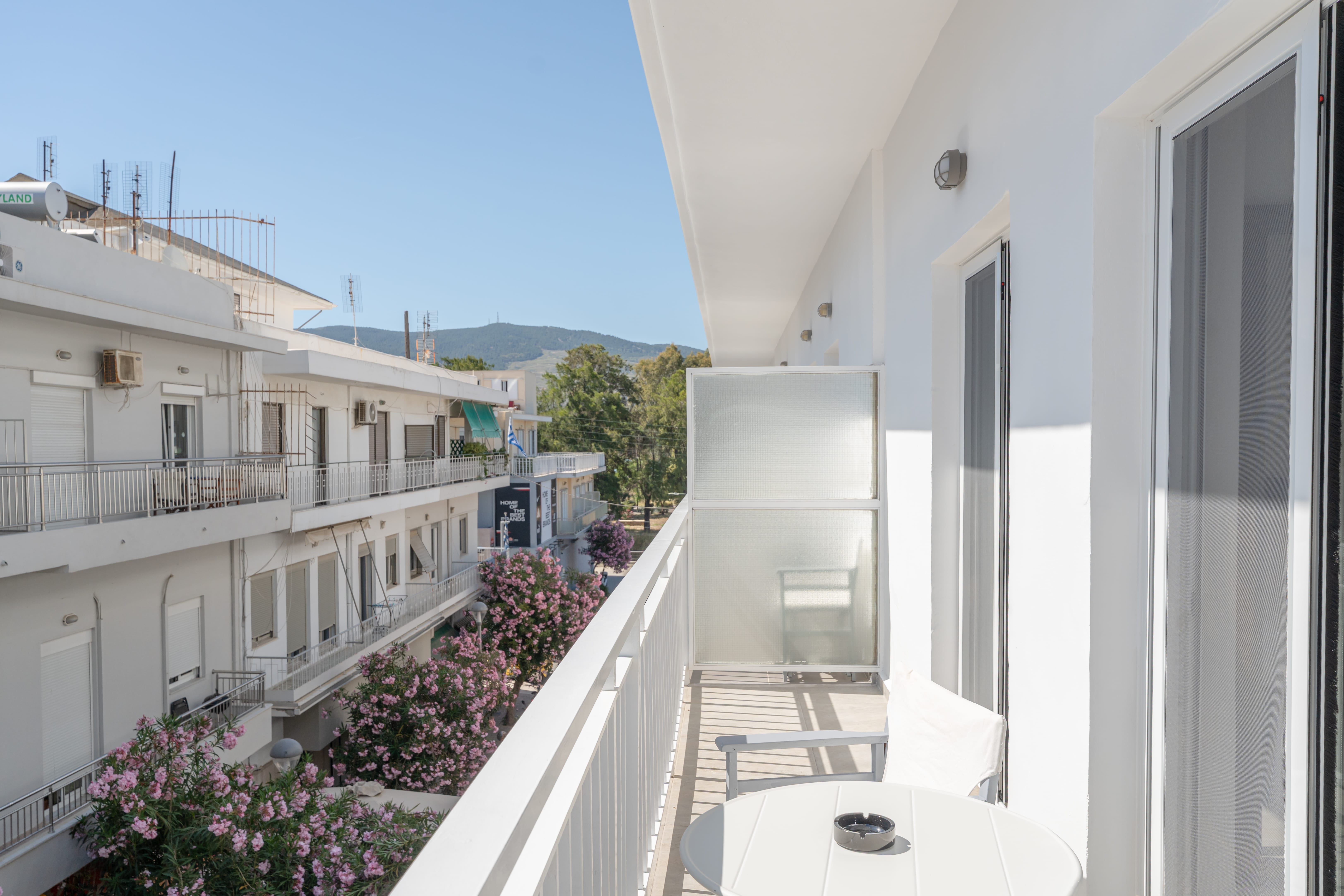 a balcony with a table and chairs