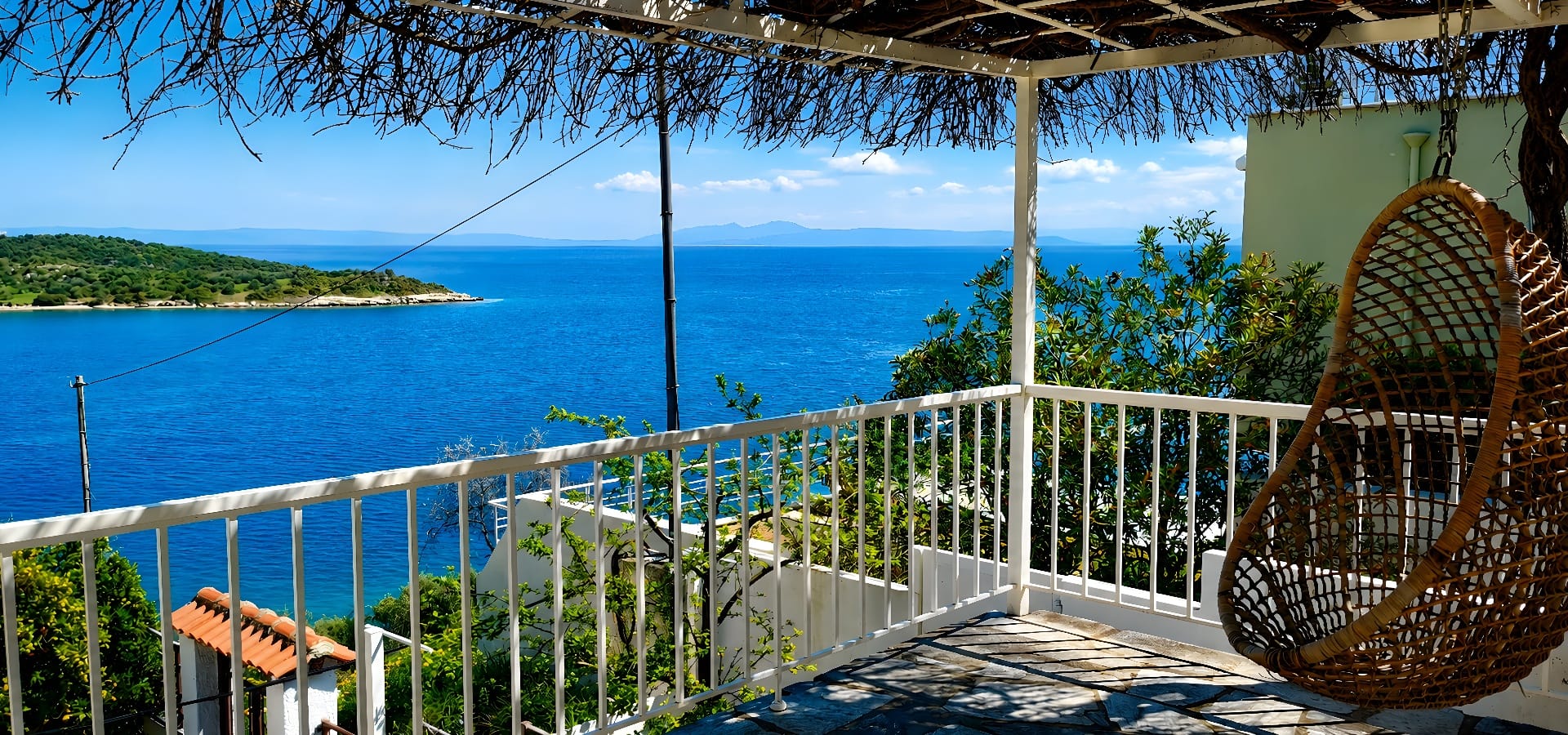 a white railing on a deck overlooking a body of water