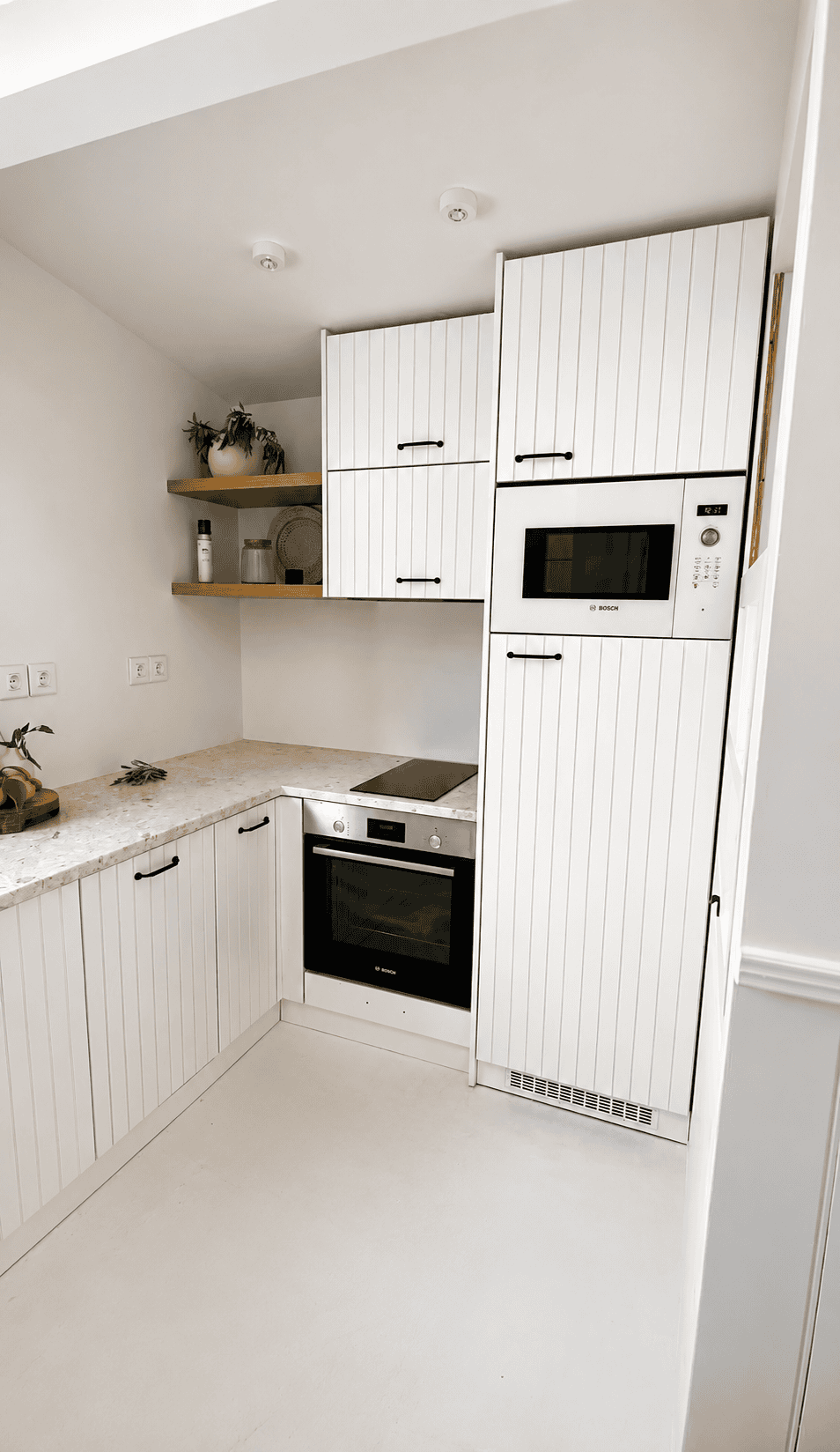 a kitchen with white cabinets