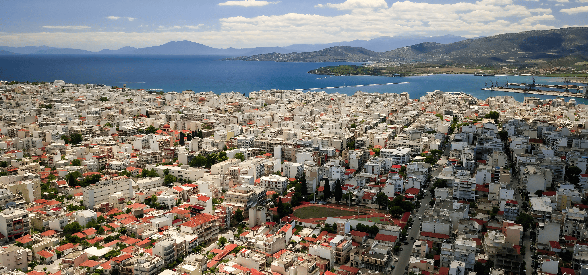 a city with a body of water in the background
