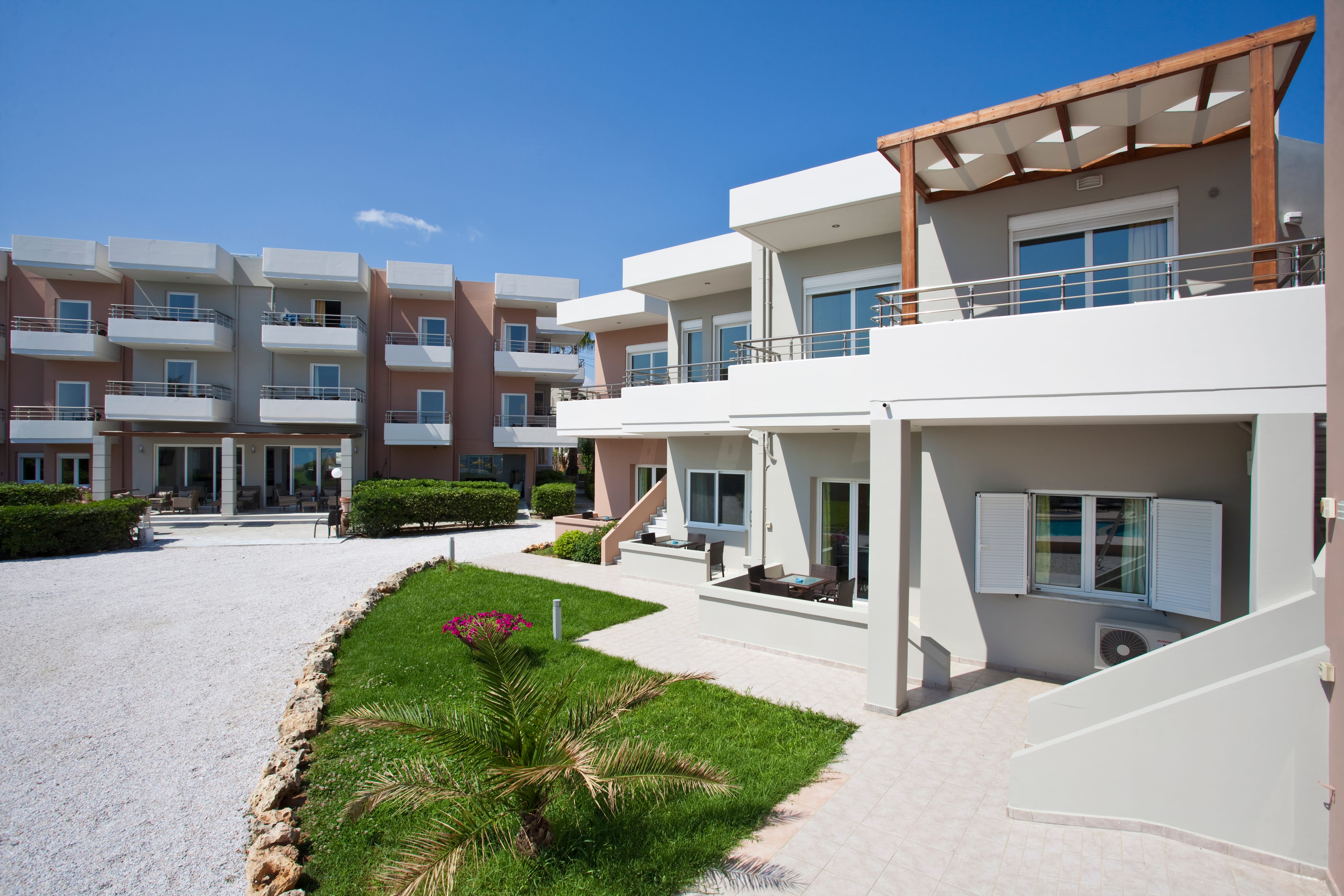 a building with a walkway and grass