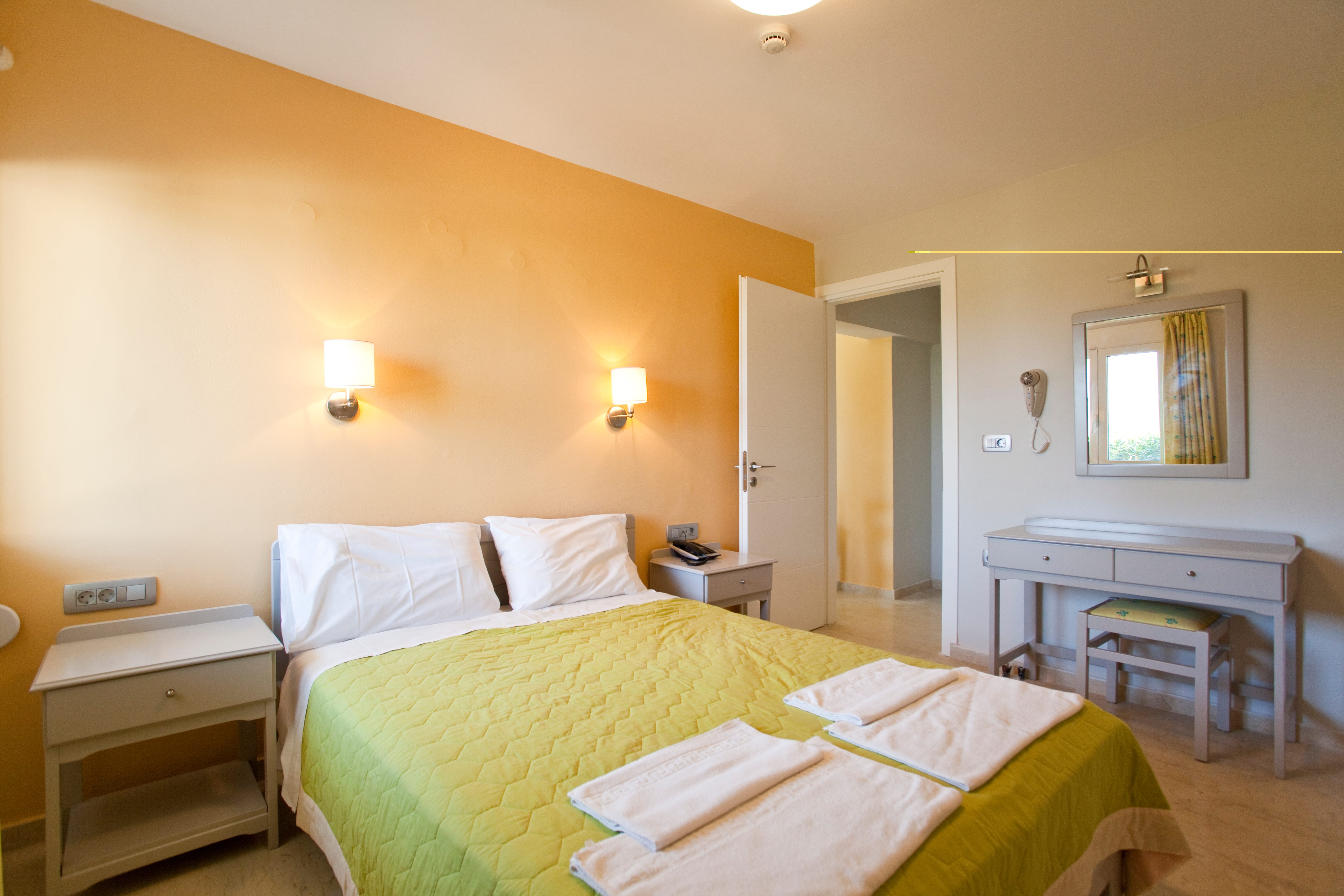 a bedroom with a bed and a desk