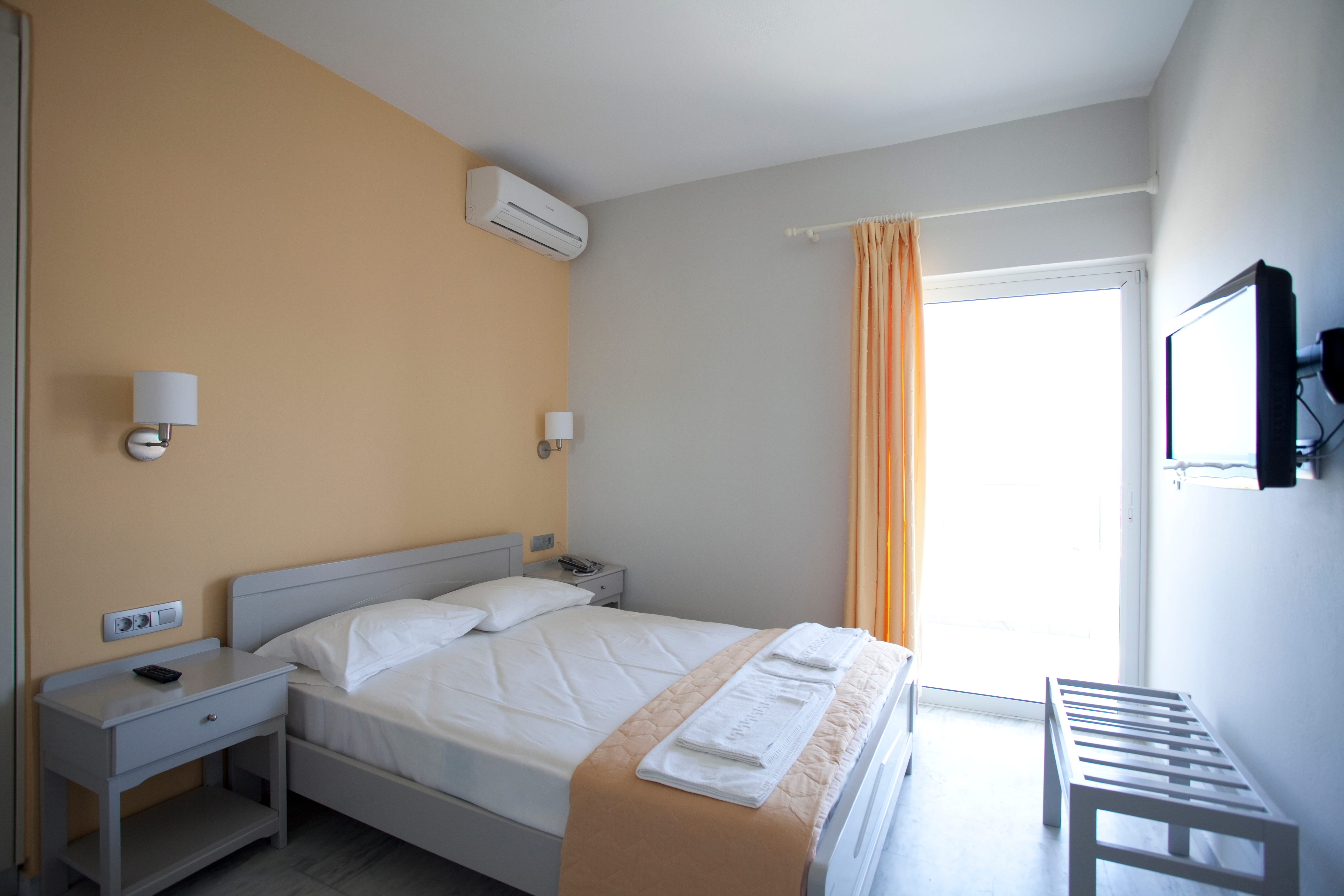 a hotel room with a bed and a tv